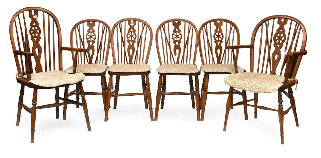 A Set of Six Oak Wheel Back Dining Chairs
