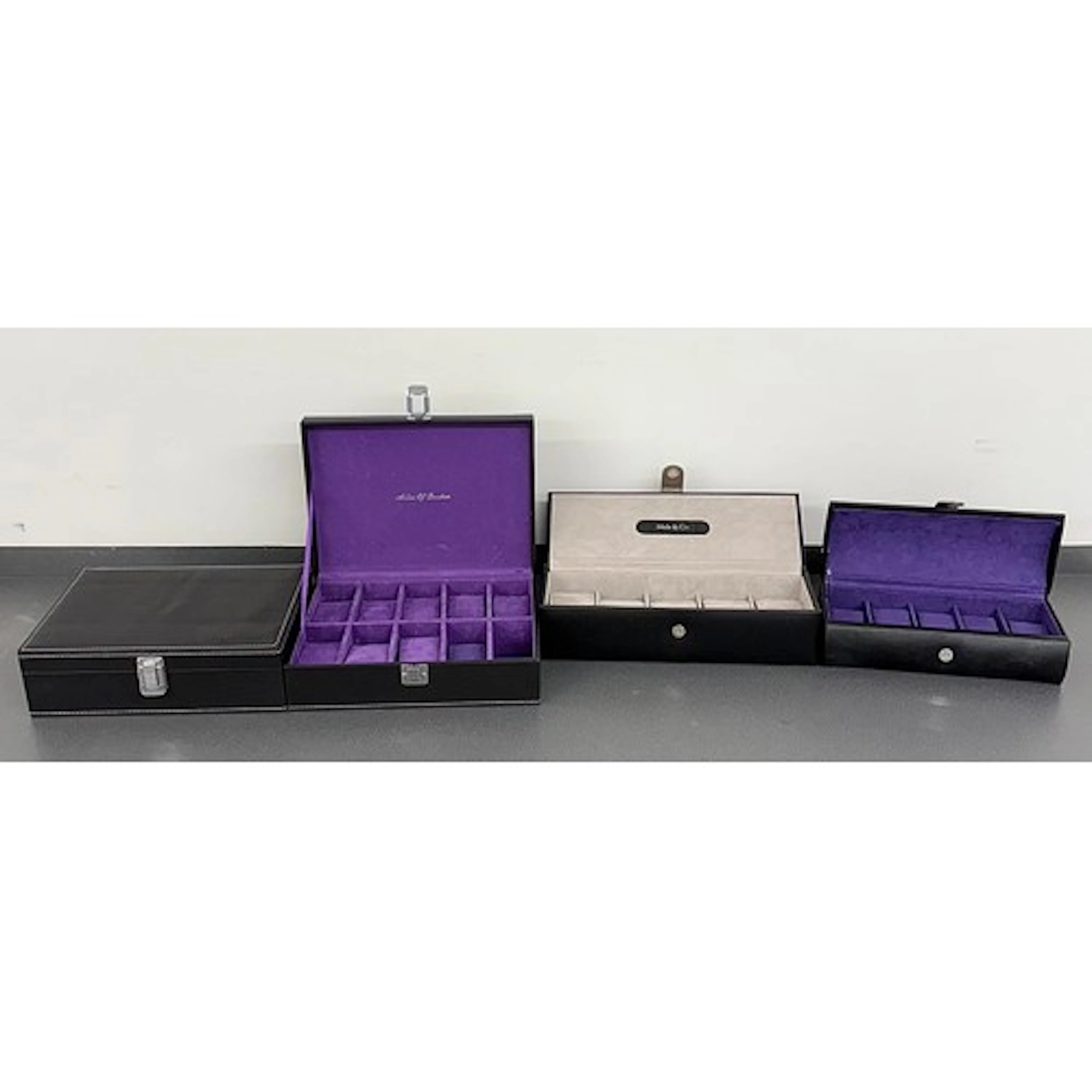 Two Aston of London black ten compartment watch storage case...
