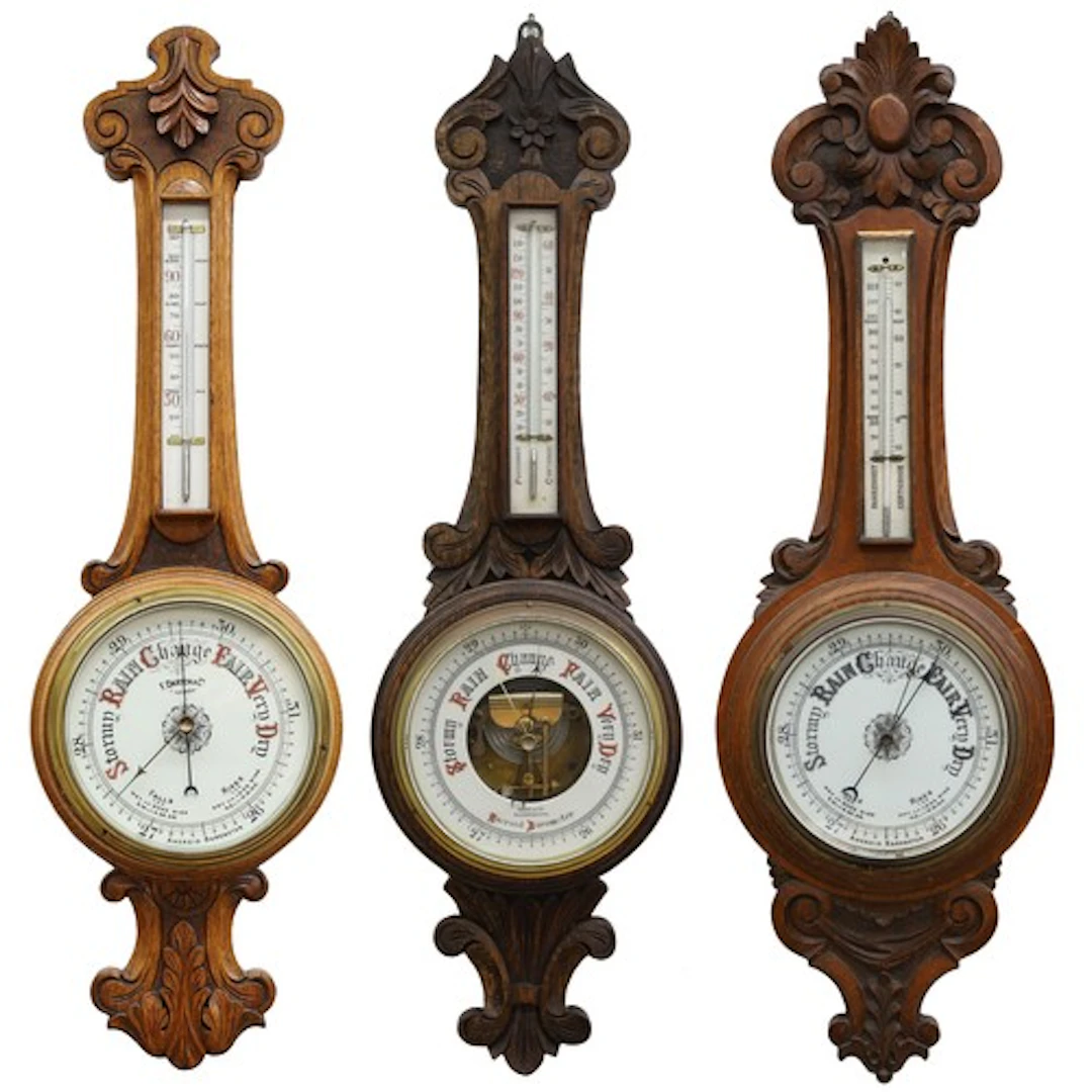 Group of three oak aneroid barometers, each with circular po...