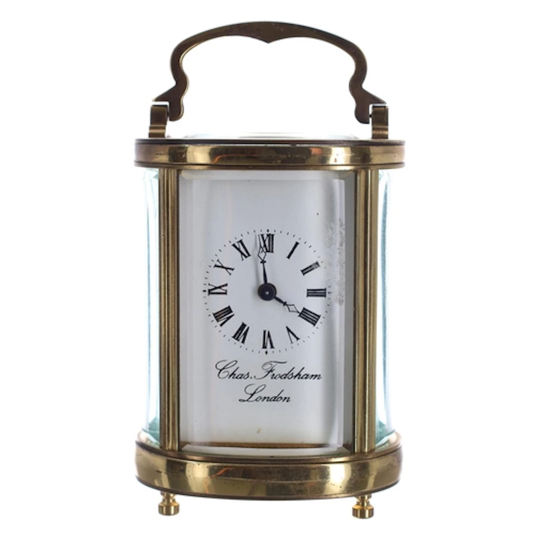Miniature oval brass carriage clock timepiece, the Roman num...