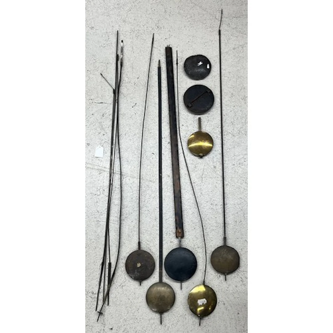 Group of longcase clock pendulums in brass and lead, one wit...