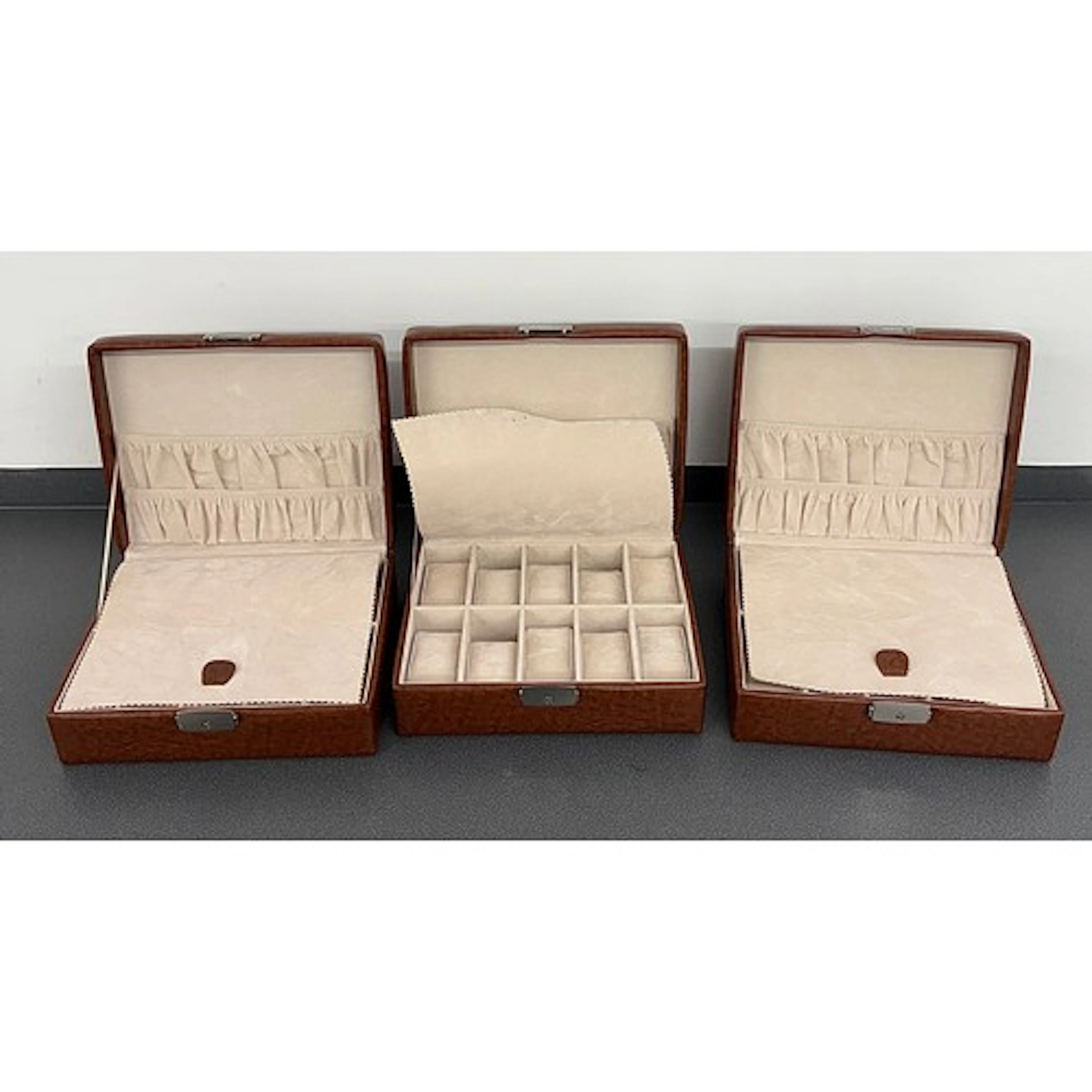 Three brown ten compartment watch storage cases, 9.25'' wide...