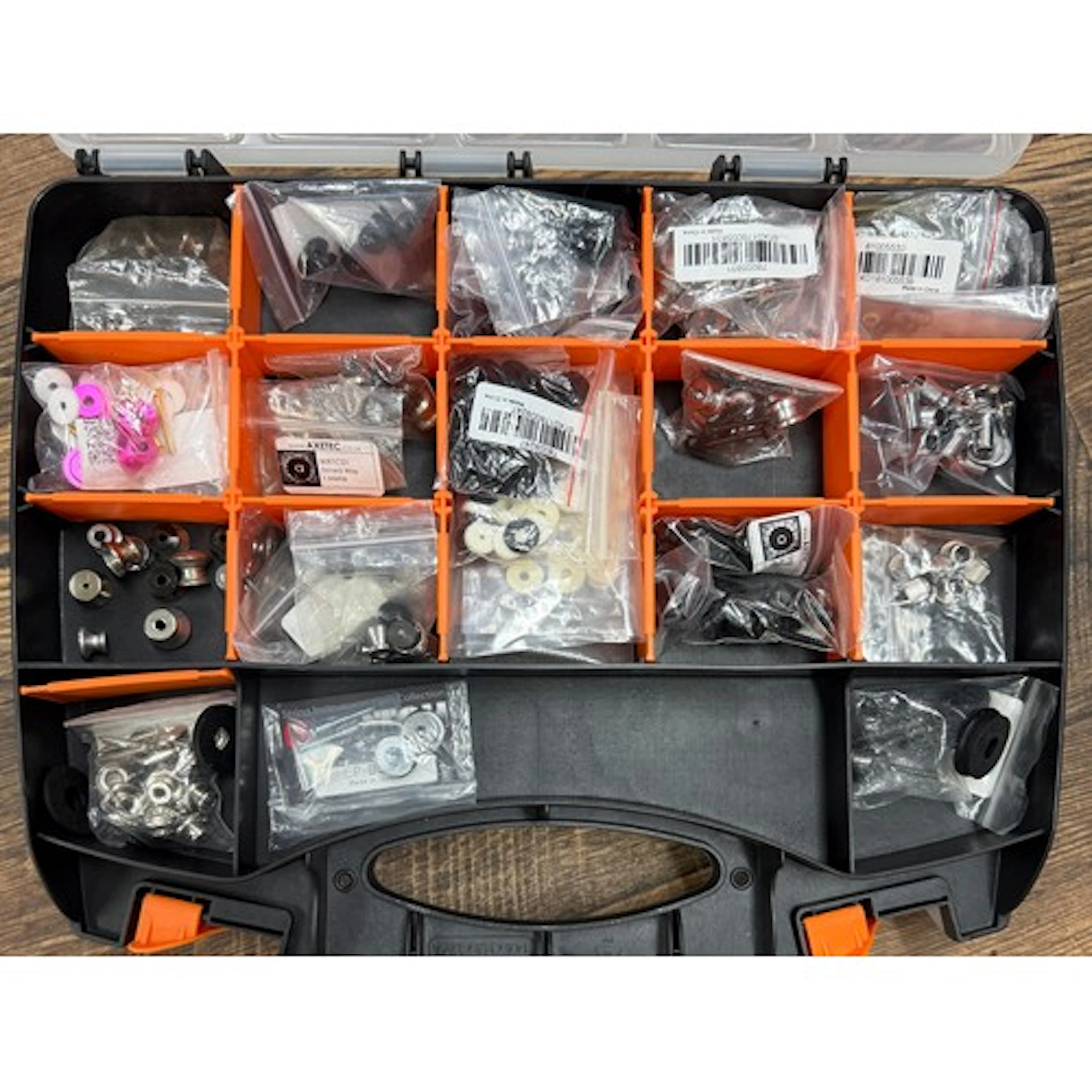 Double-sided plastic organiser box containing various plasti...