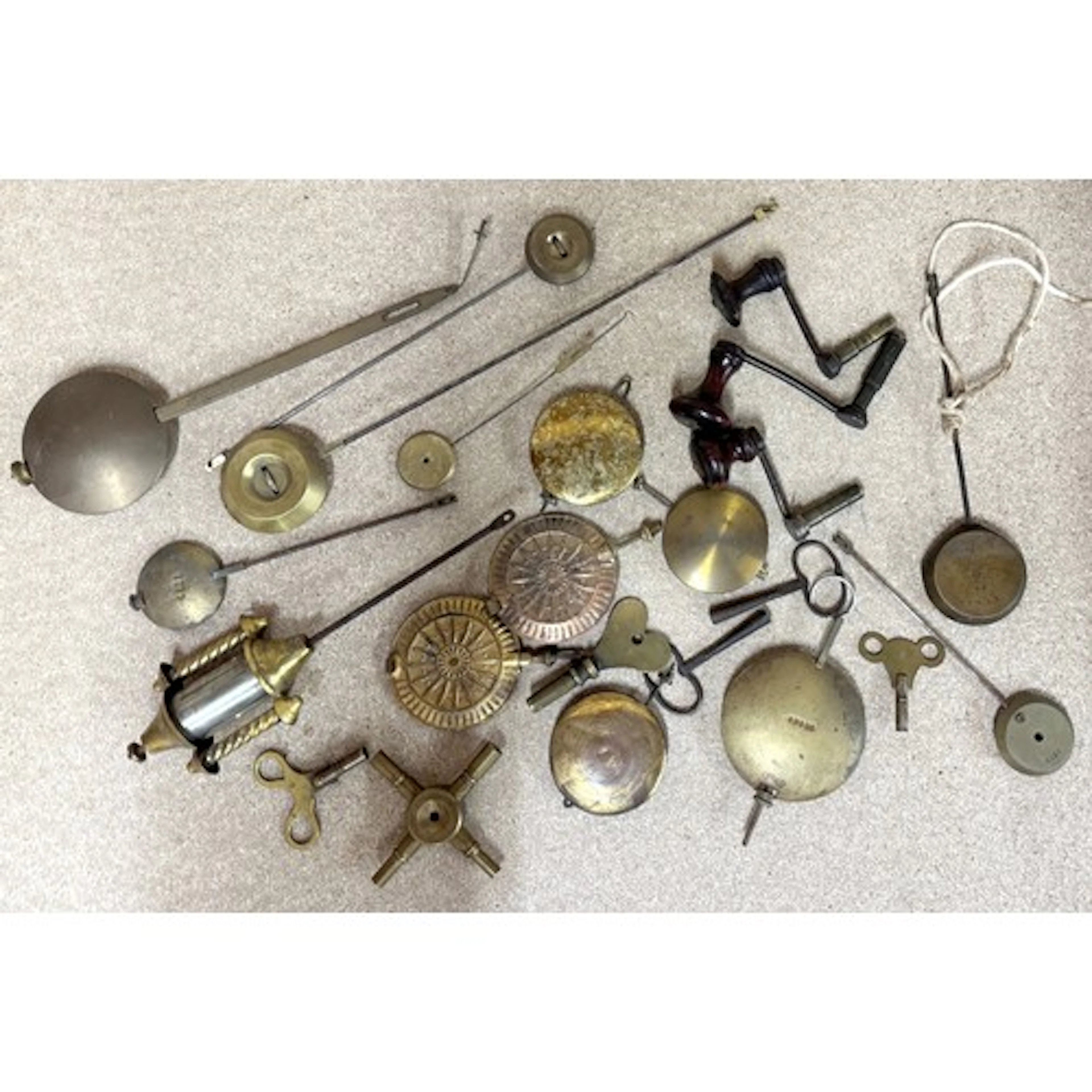 Selection of clock pendulums, winding keys etc...