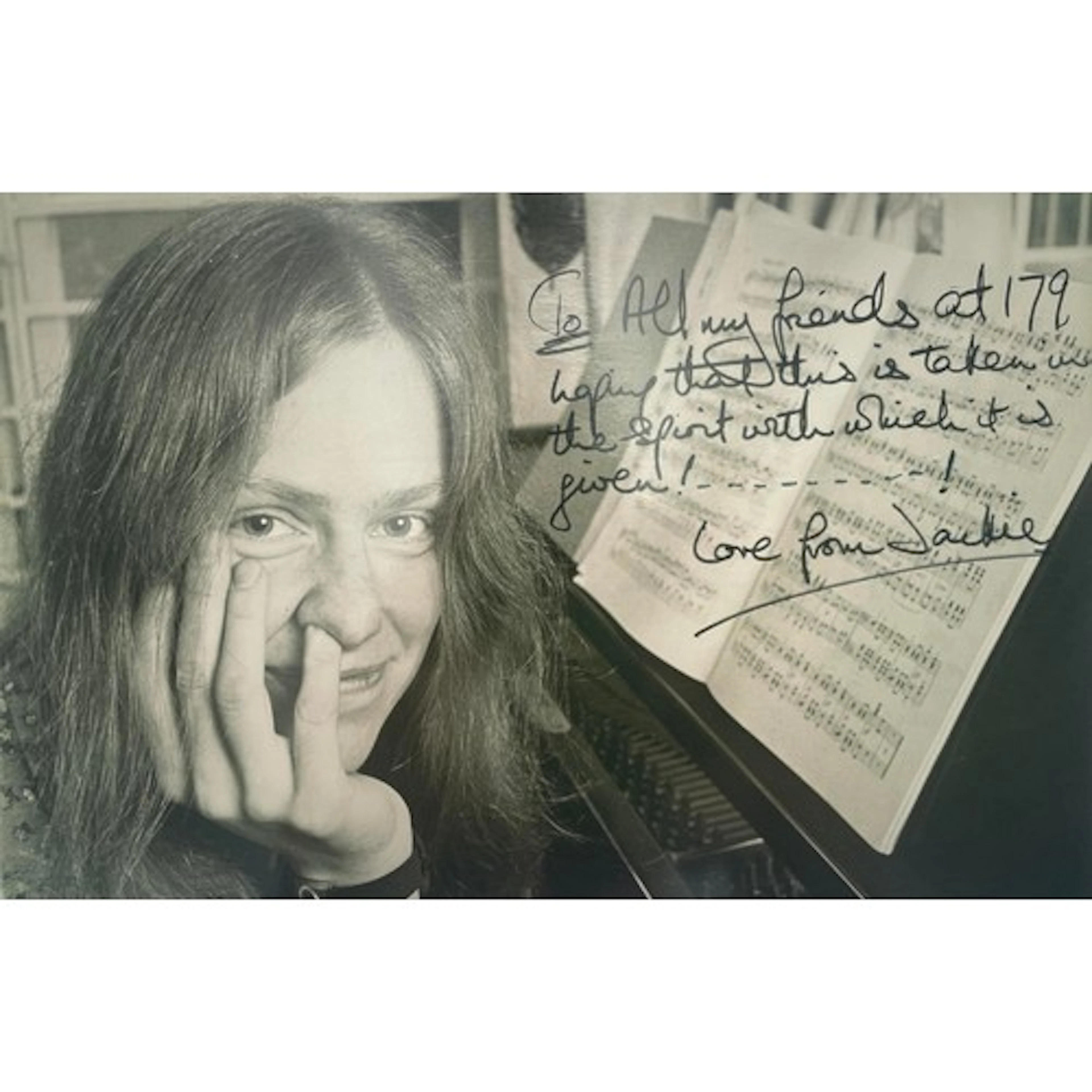 A photograph - Jacqueline du Pré, posing by the piano, resti...