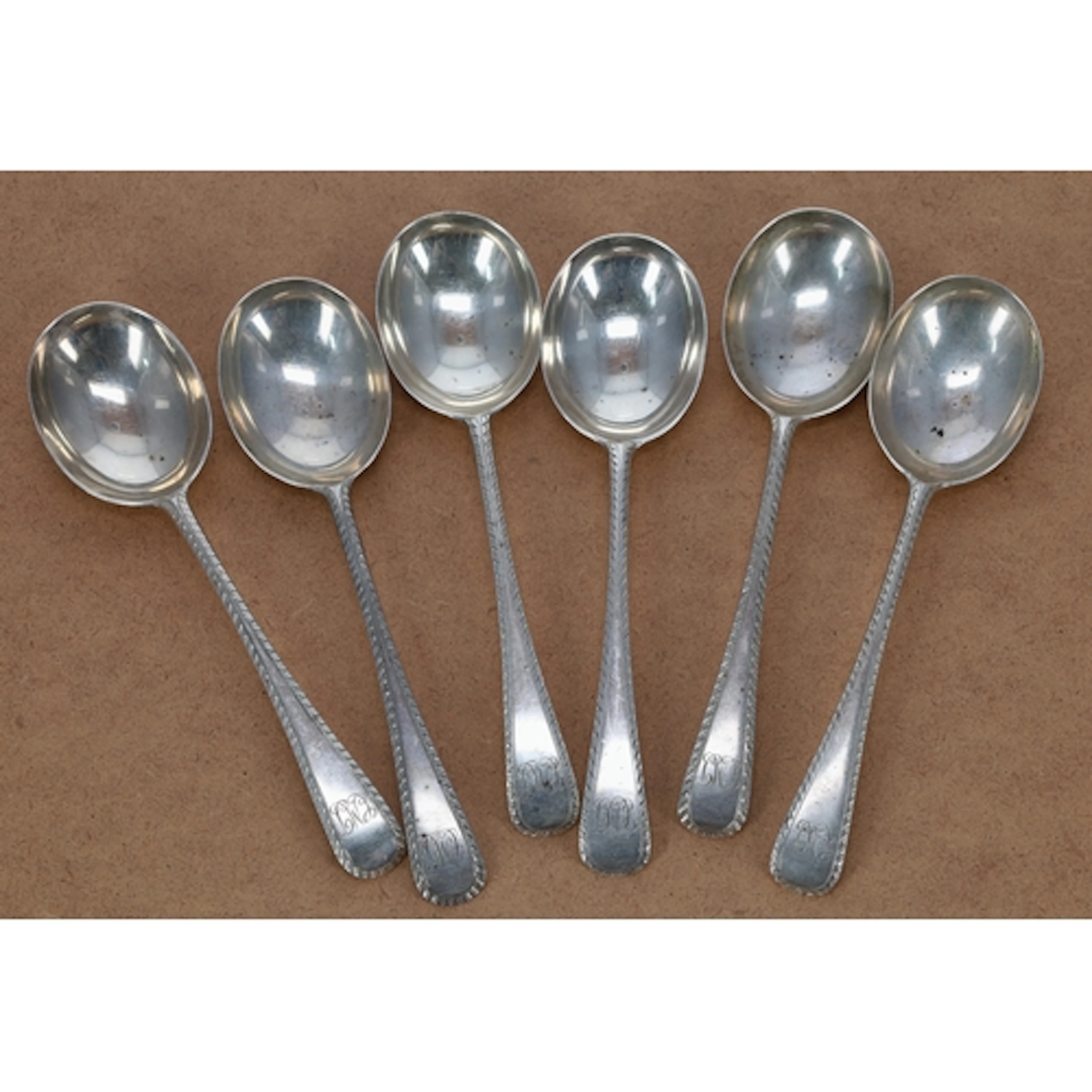 Matched set of six early 20th century silver feather edge ol...
