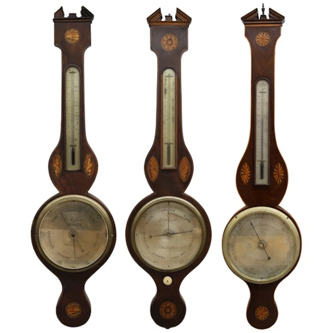 Group of three 19th century shell inlaid mahogany wheel baro...