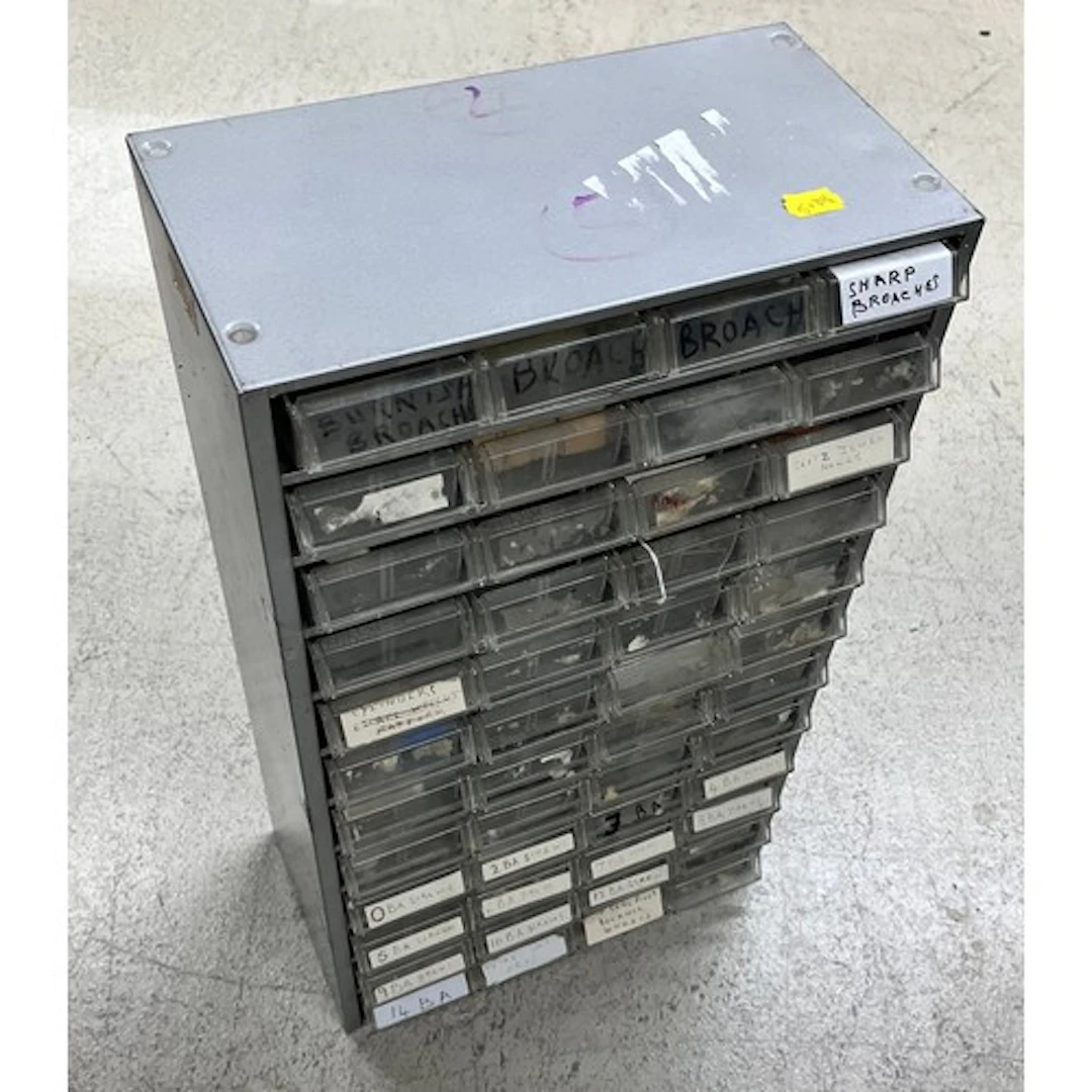 Metal multi-drawer storage cabinet containing a quantity of ...