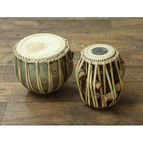 Two Indian tabla drums labelled 'Bina Musical Stores, Made i...