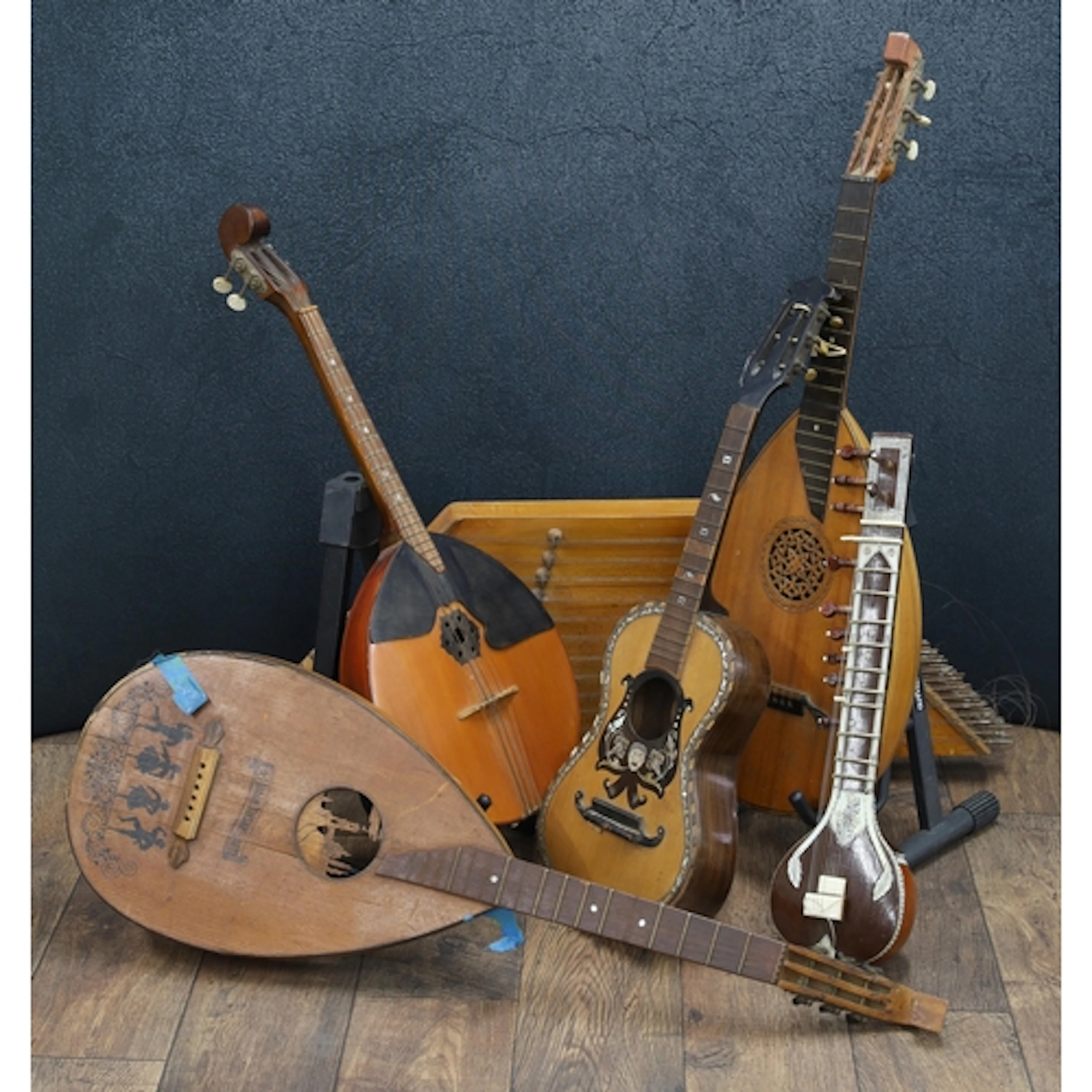 Two old lute guitars in need of restoration; together with a...