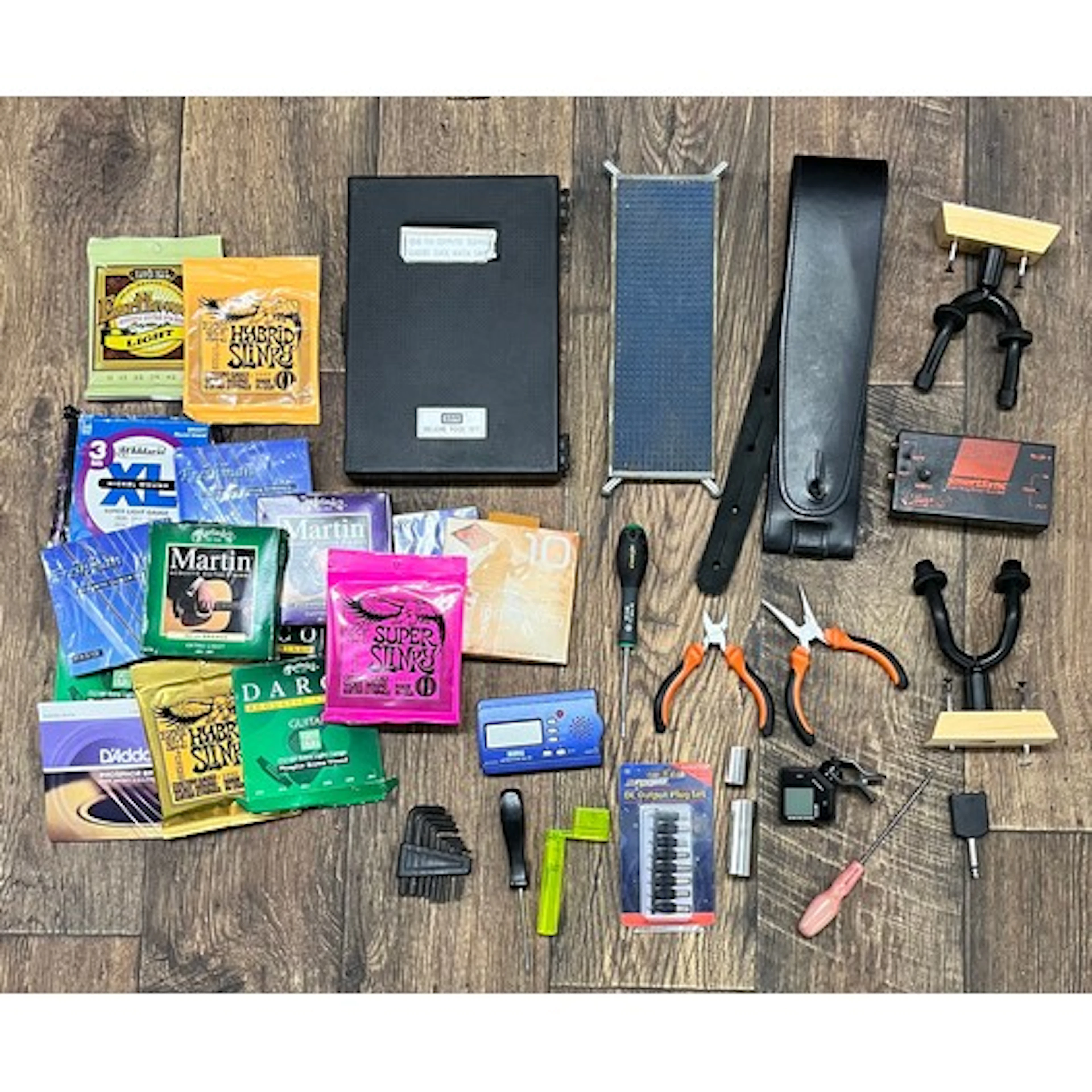 Approximately fifteen packs of various branded guitar string...