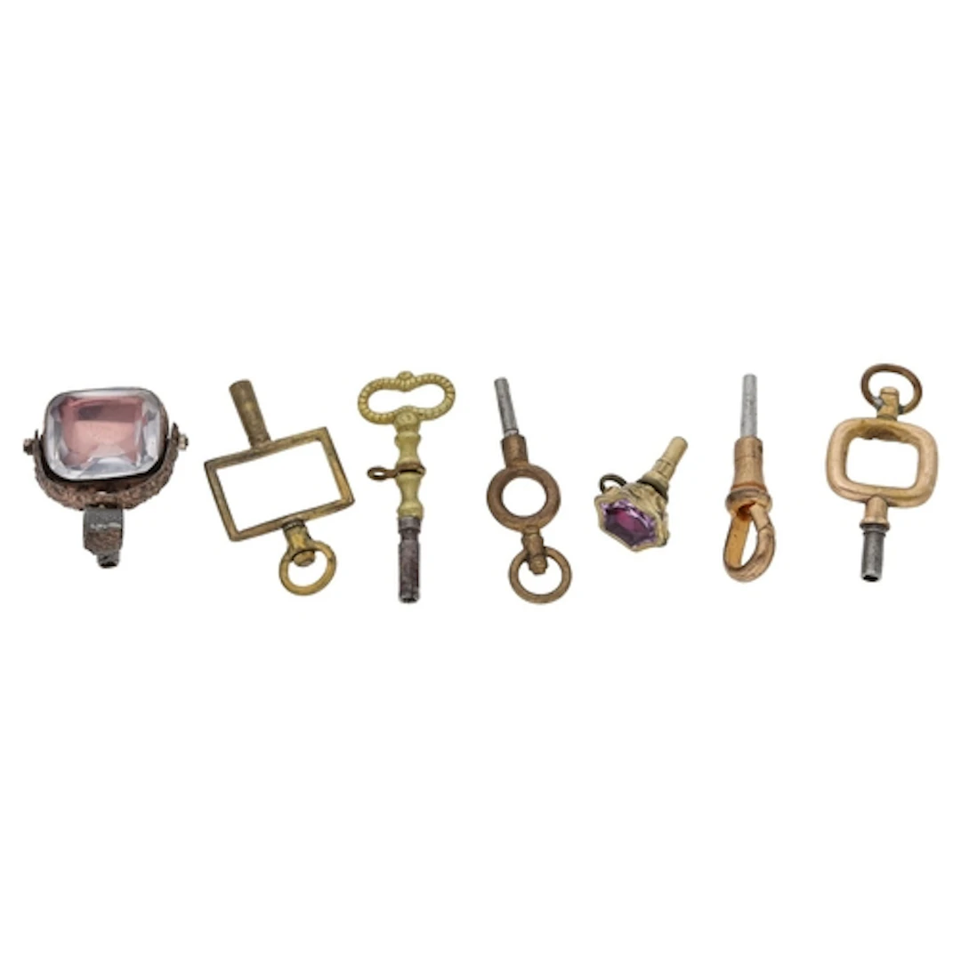 Seven assorted pocket watch keys to include two stone set ke...