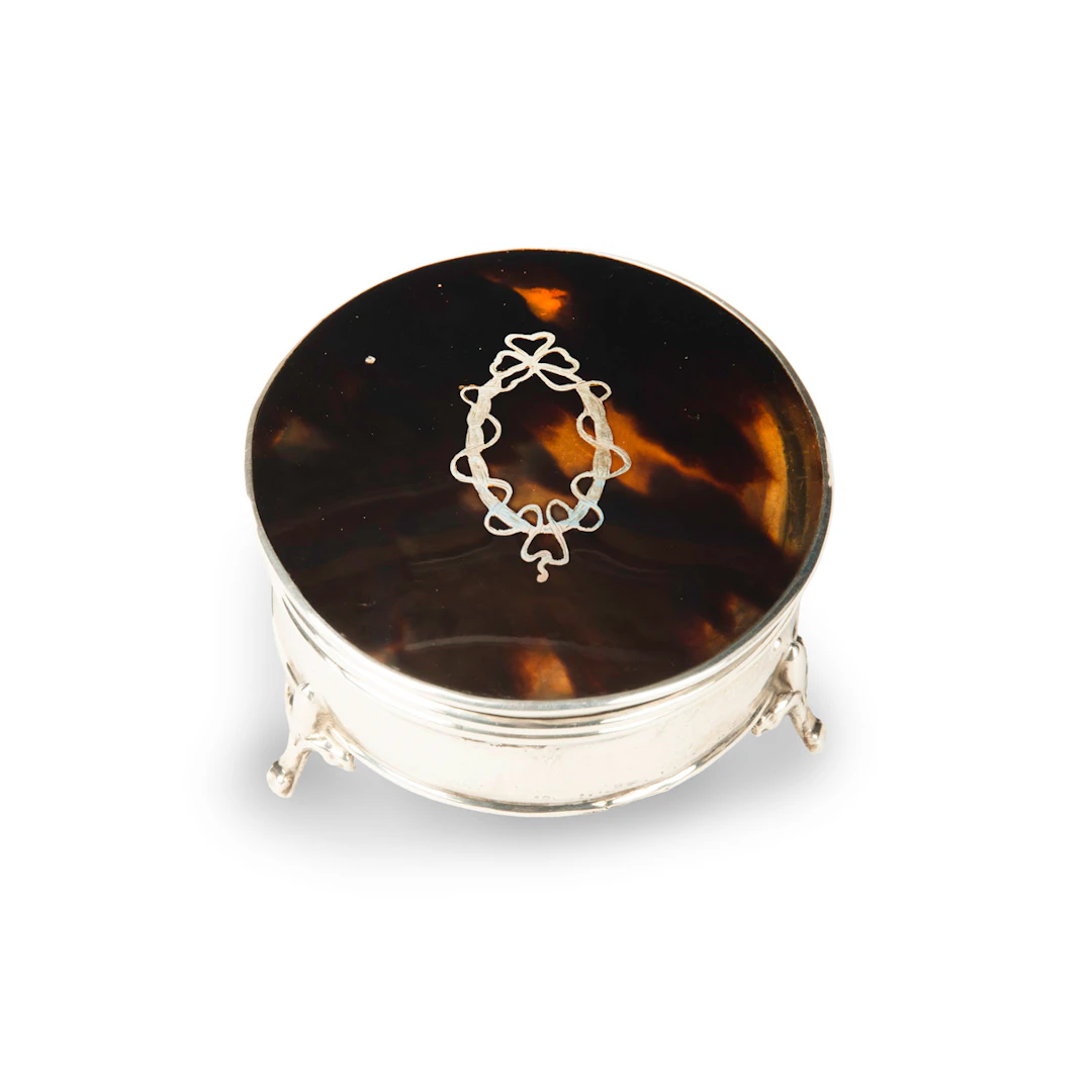 A small circular tortoiseshell piqué patch pot by Mappin and Webb