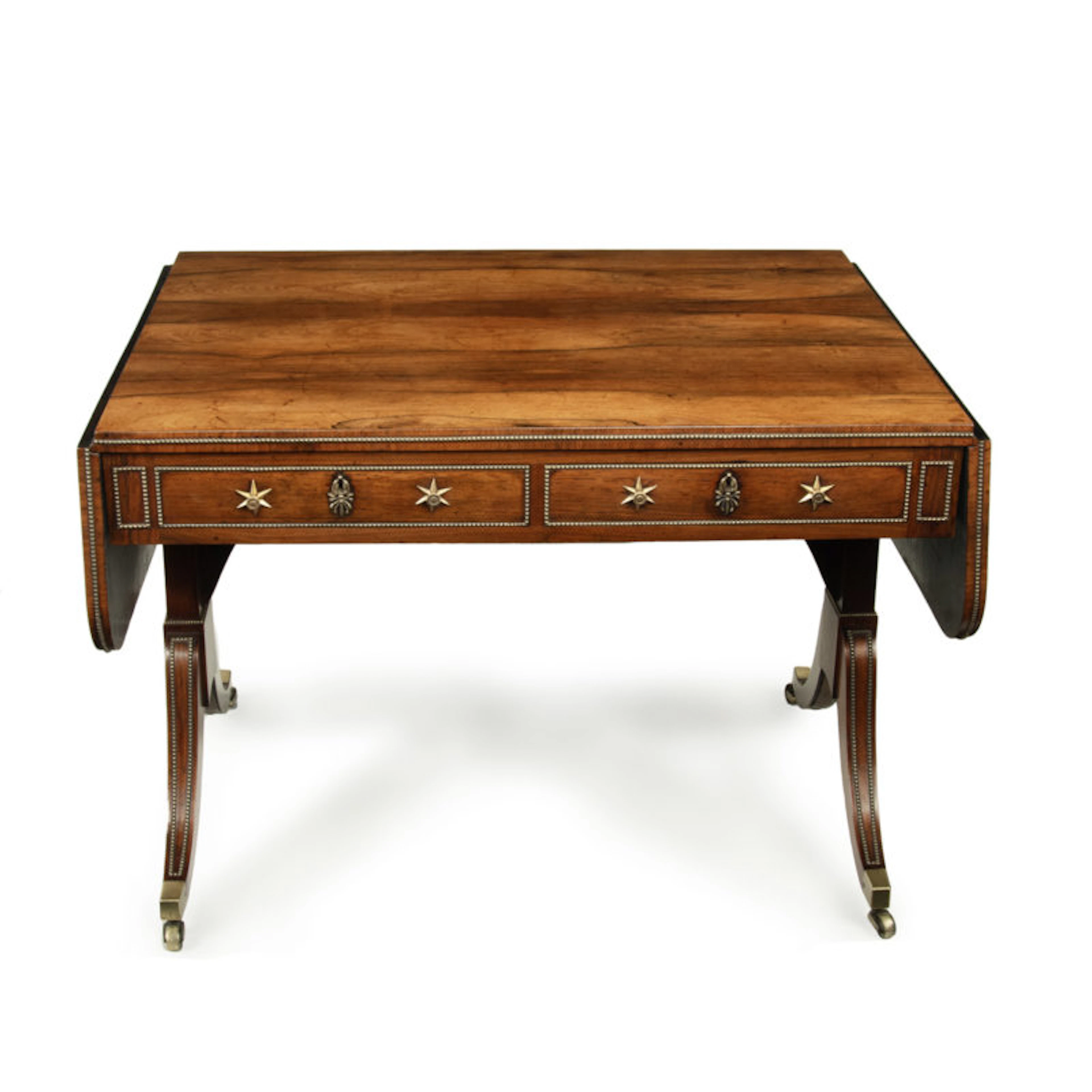 A Regency brass-inlaid rosewood sofa table attributed to Gillows