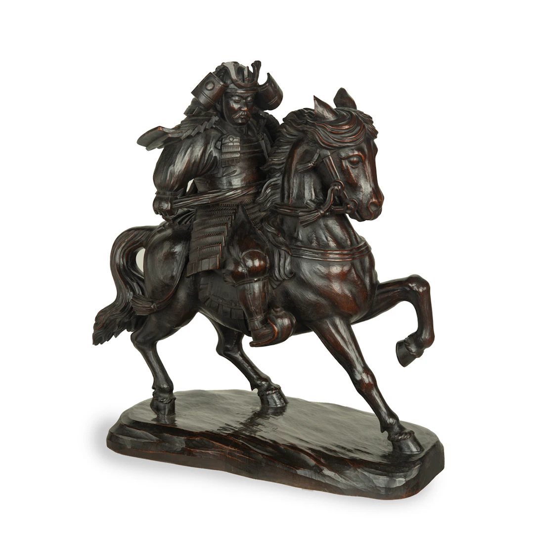 A powerful Japanese equestrian wood carving of a samurai by Yoshida