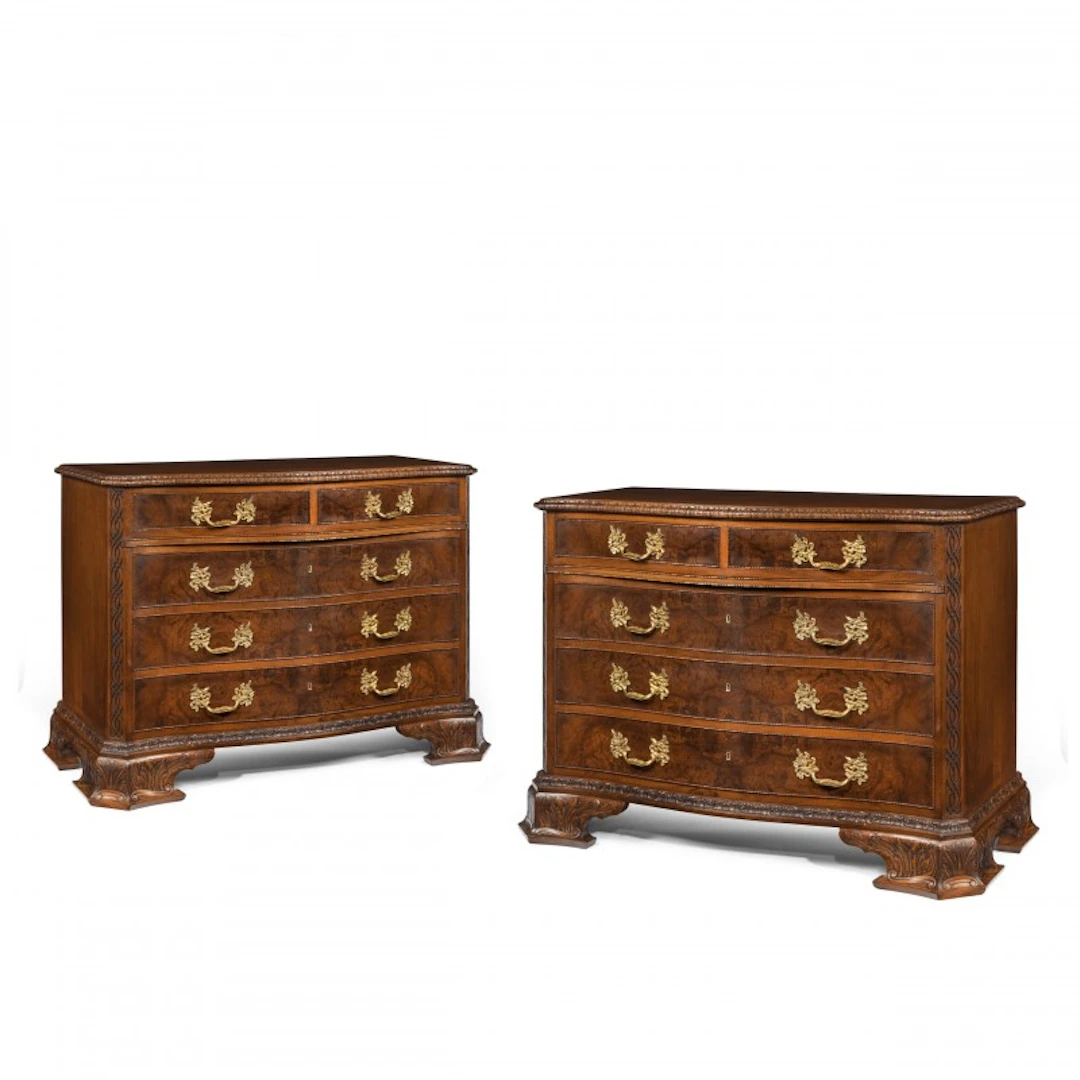 An unusual pair of early 20th century walnut serpentine commodes