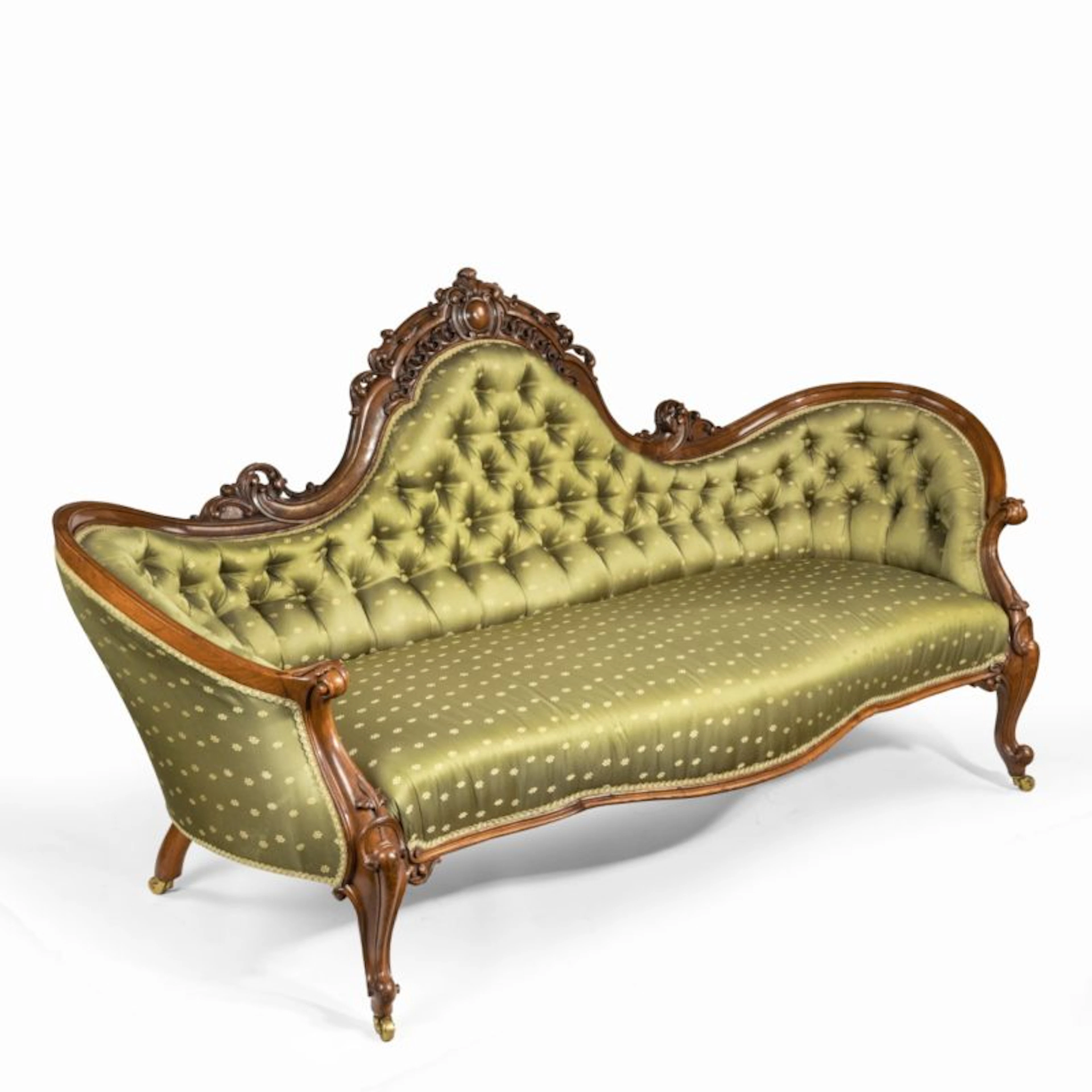 An elaborate Victorian shaped walnut sofa