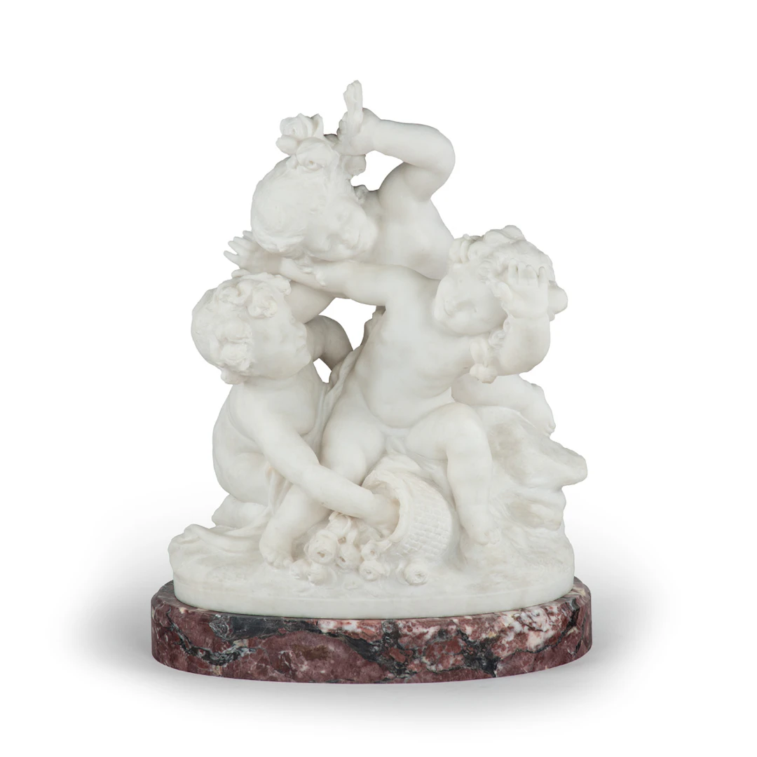 A large white marble figural group depicting three putti, Charles
