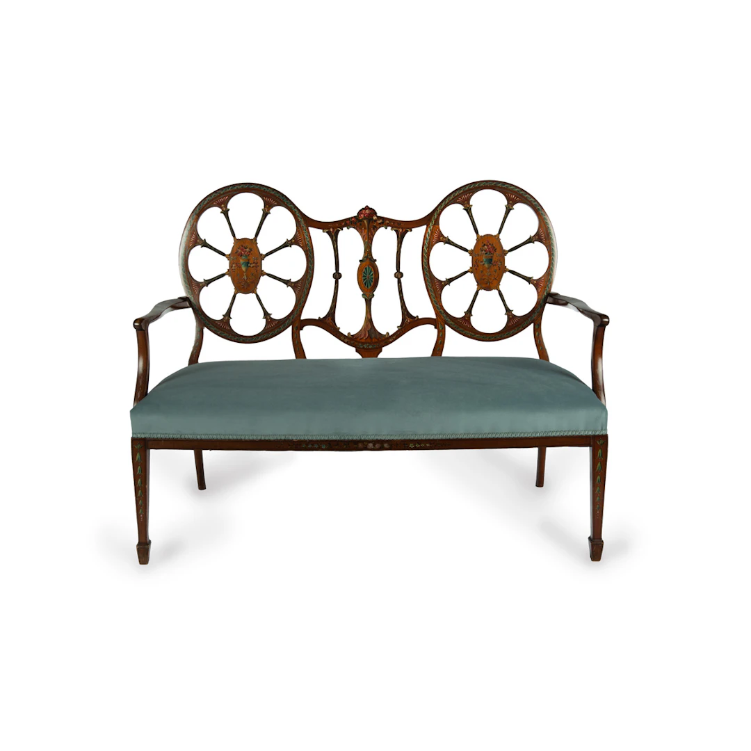 A late Victorian satinwood wheel back settee in the Chippendale style