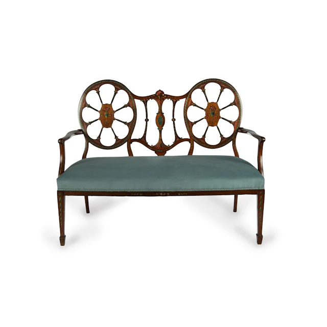 A late Victorian satinwood wheel back settee in the Chippendale style