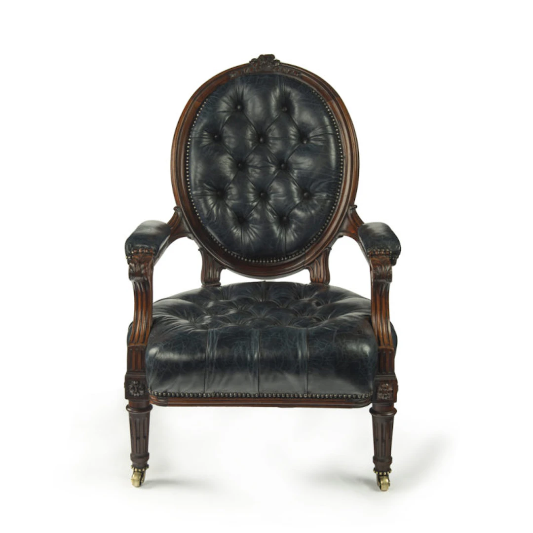 A Victorian rosewood medallion backed open arm chair by Holland & Sons