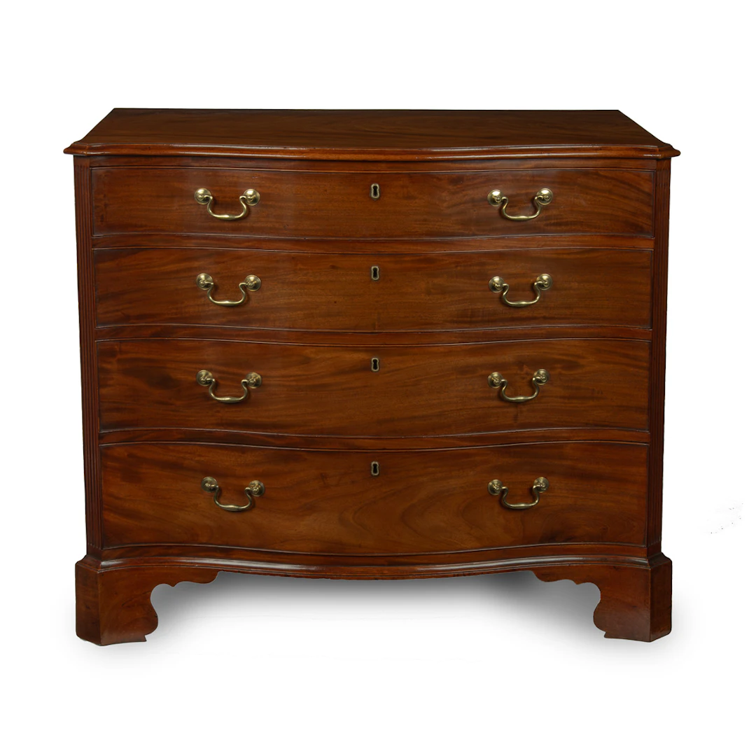 A mahogany four-drawer serpentine chest of drawers