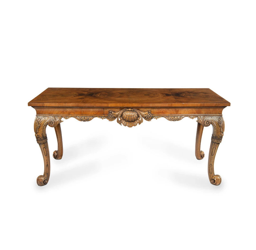 A finely carved walnut side table in the George II style by the Harry