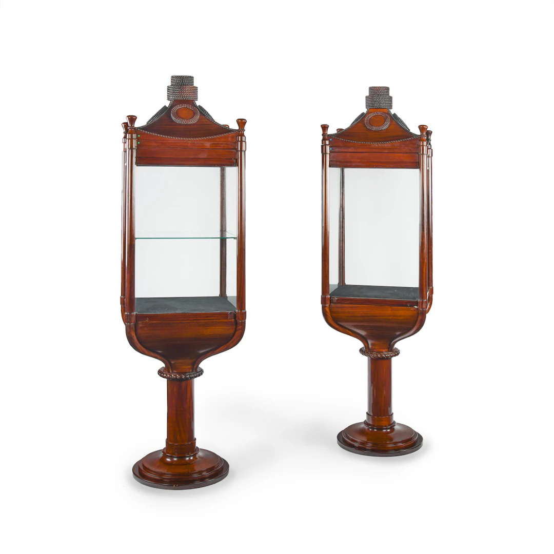 A rare pair of mahogany revolving nautically themed display cabinets