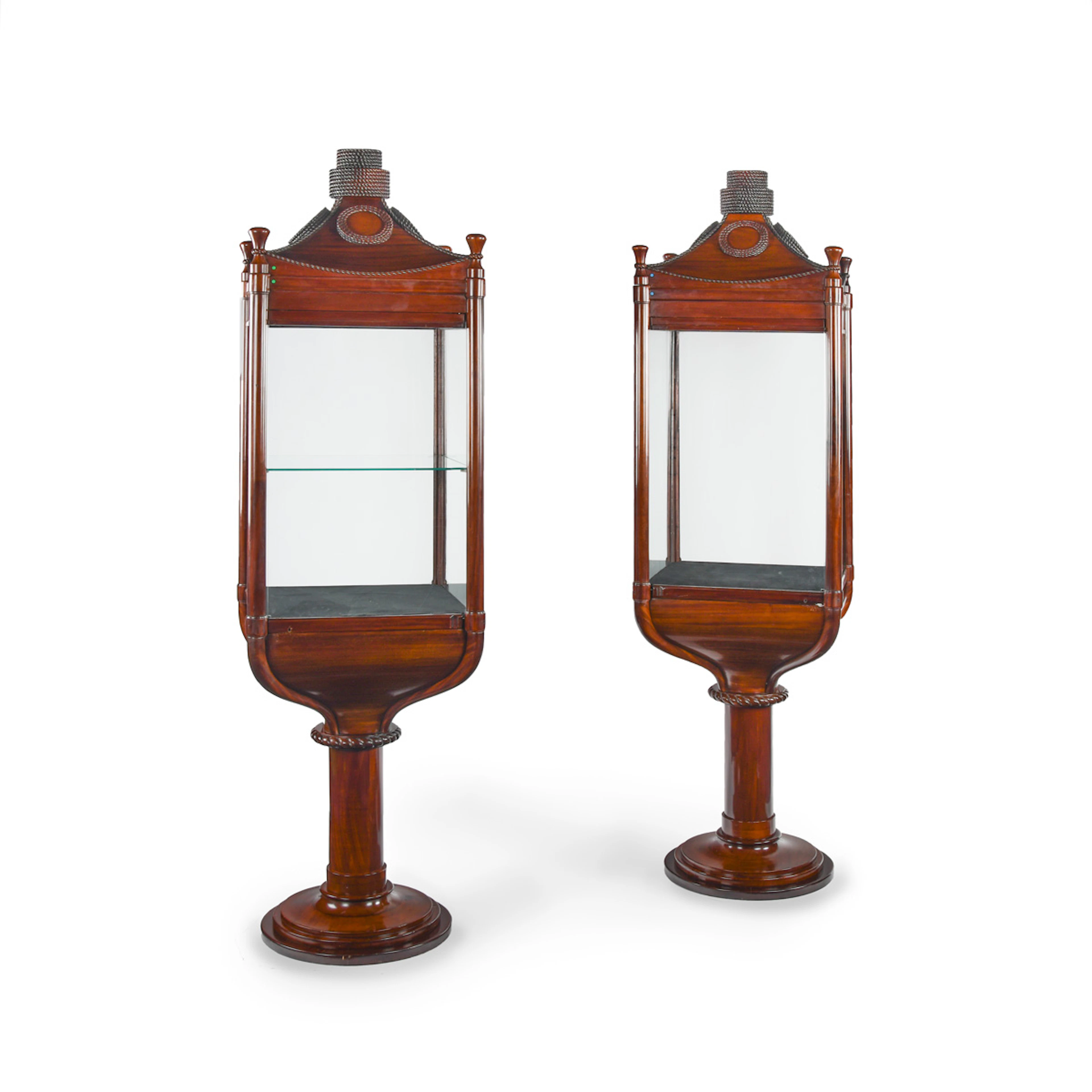 A rare pair of mahogany revolving nautically themed display cabinets