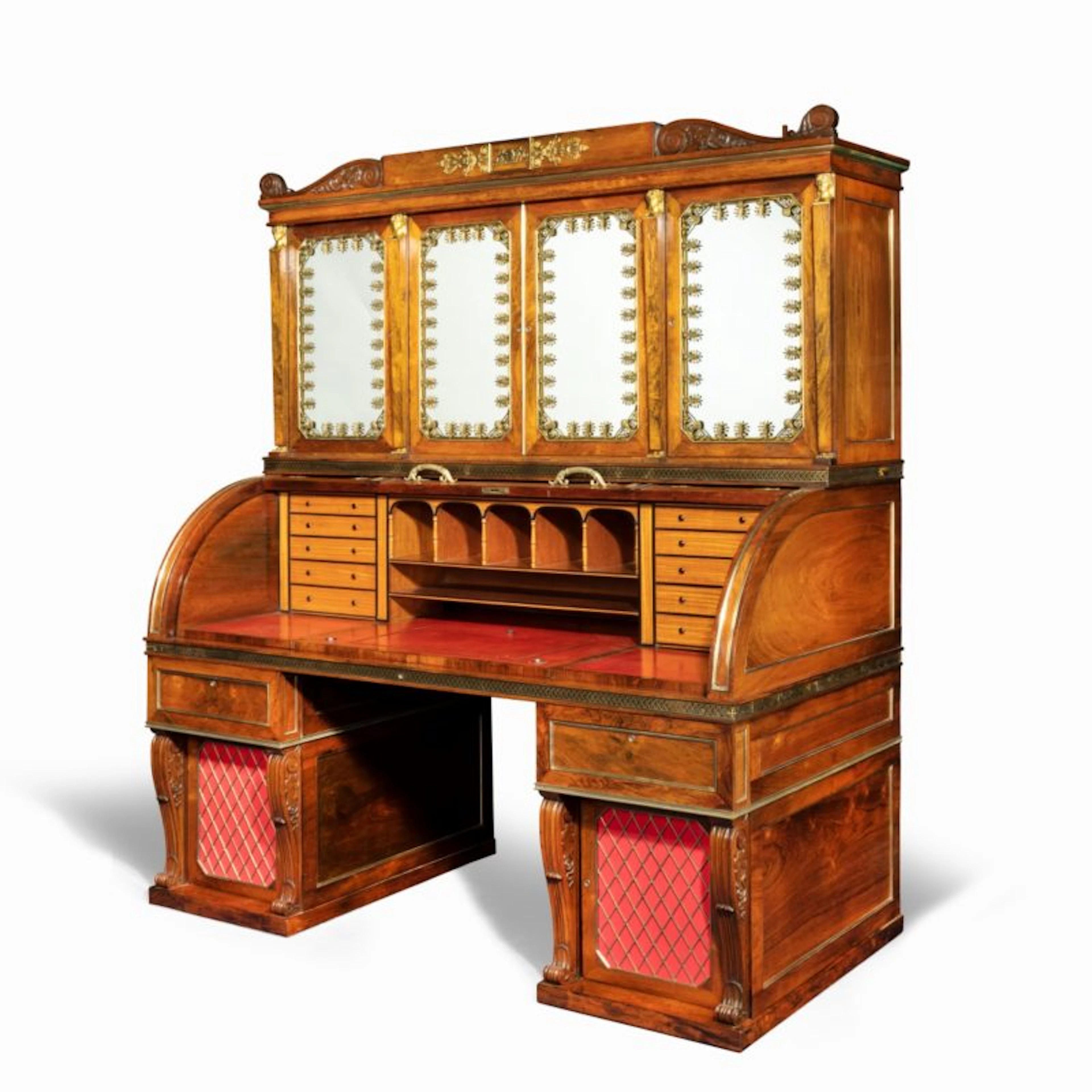 An impressive and monumental rosewood Regency kneehole bureau cabinet