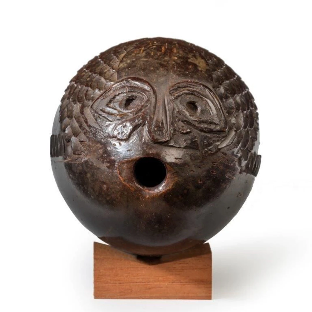 A naïve coconut shell “bugbear” powder flask carved as a fish