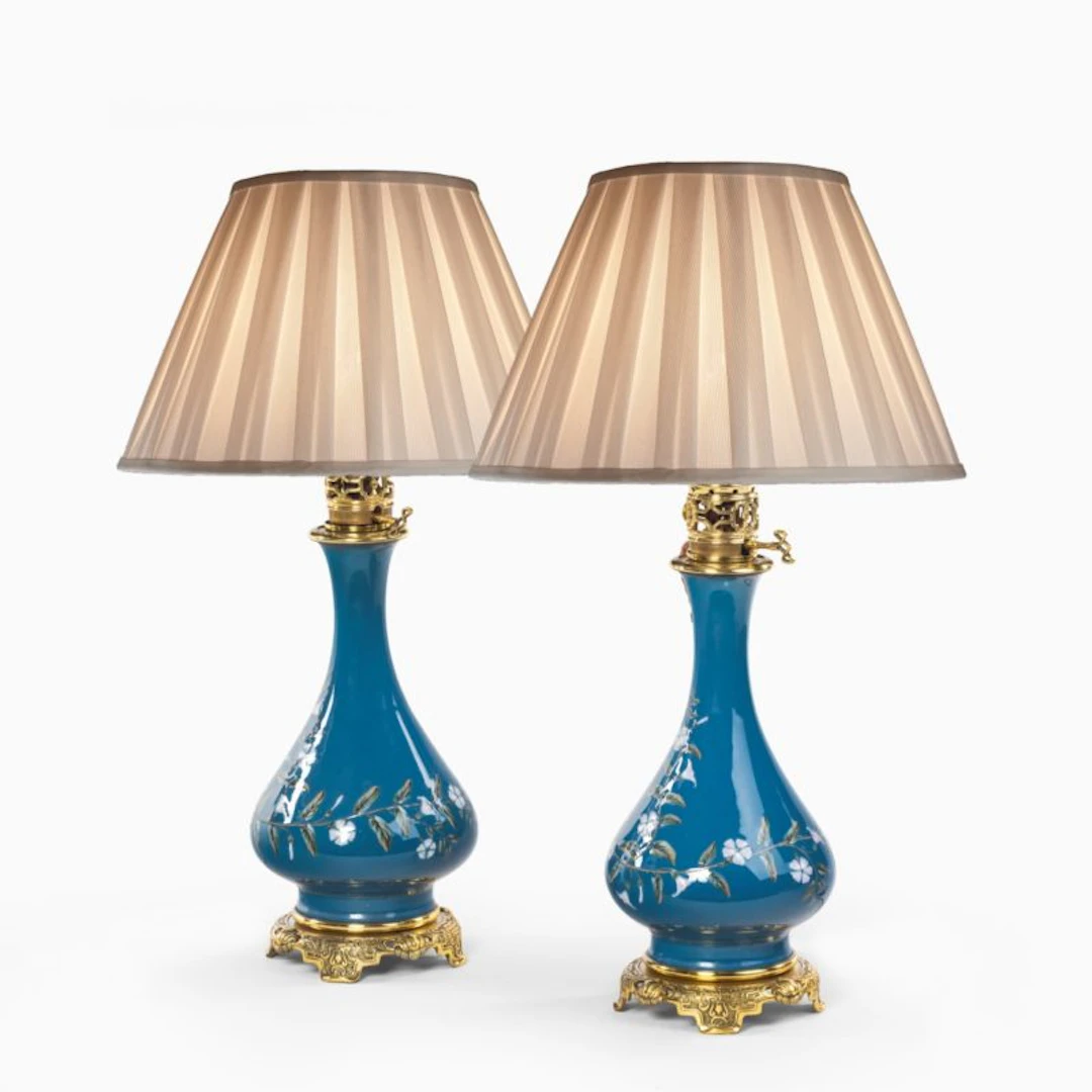 A pair of French pate-sur-pate ceramic oil lamps