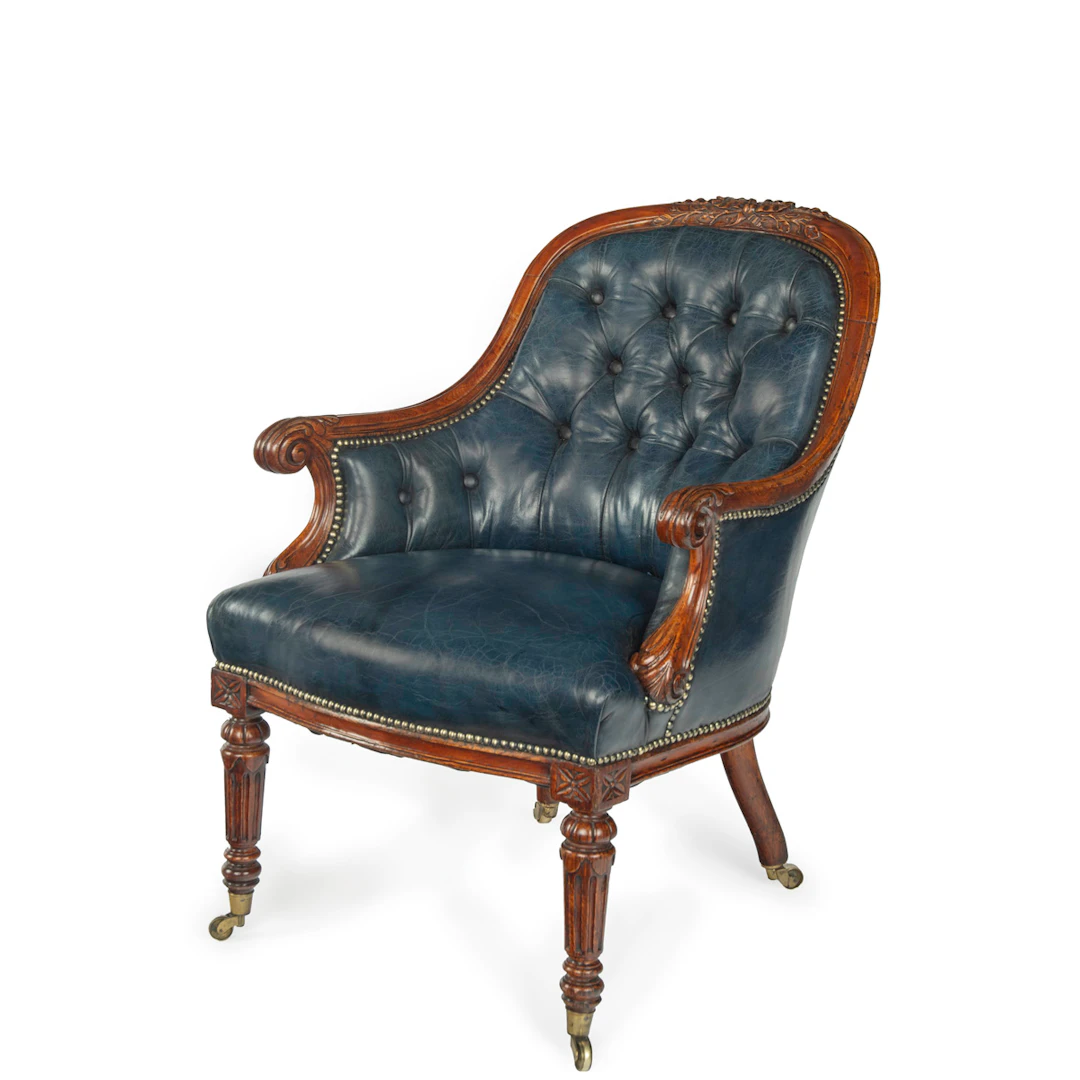 A Victorian blue leather oak library chair