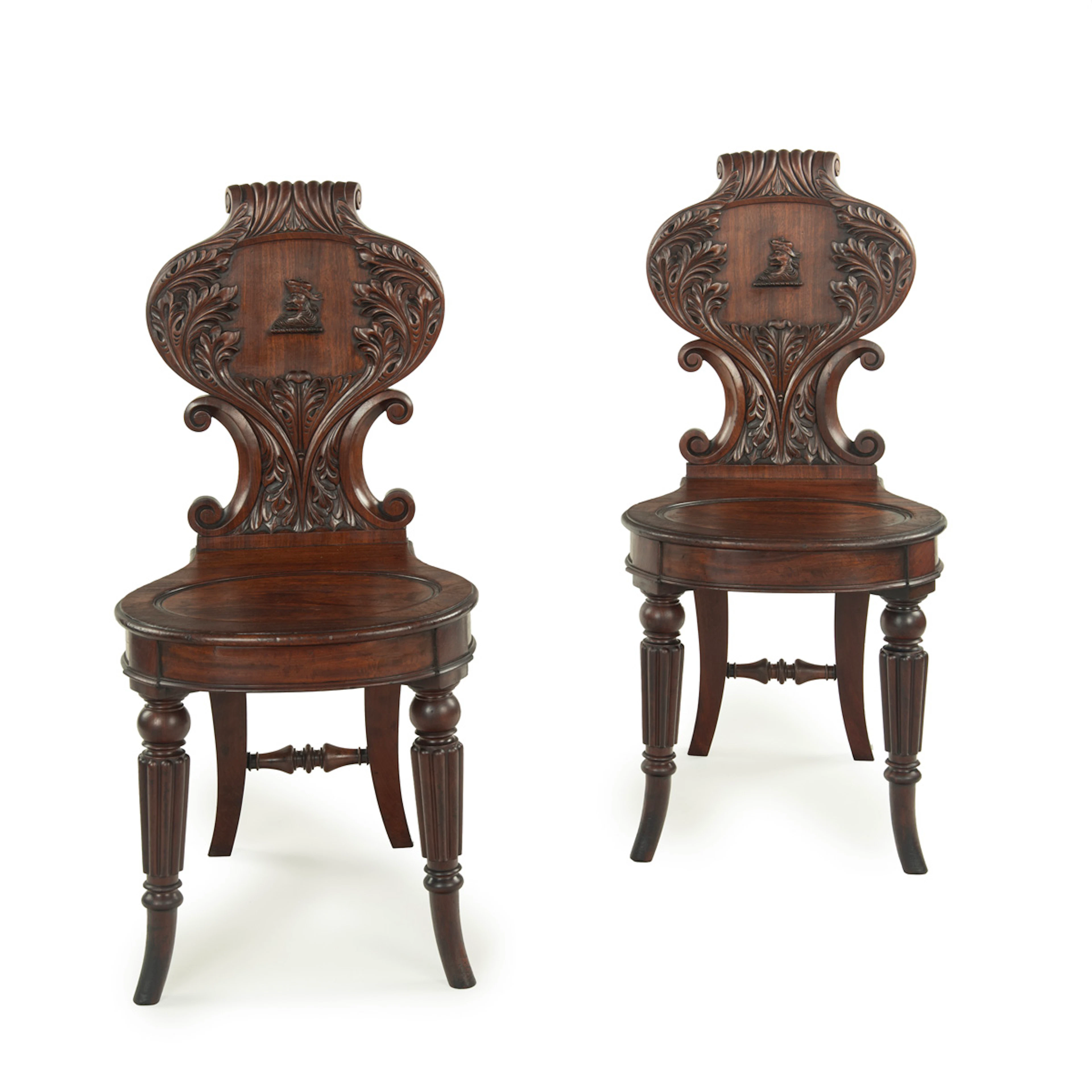 A fine pair of Regency mahogany armorial hall chairs attributed Gillows