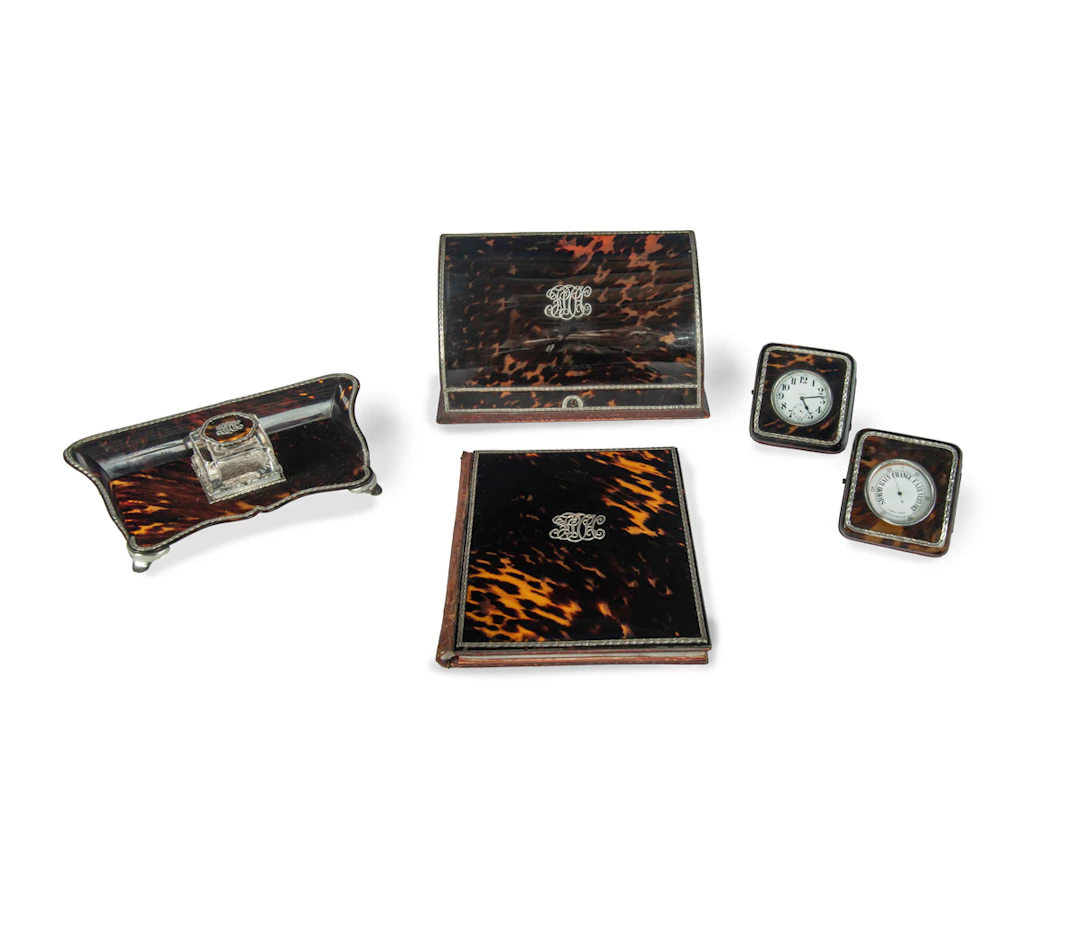 An extensive Edwardian 5-piece silver mounted tortoiseshell desk set