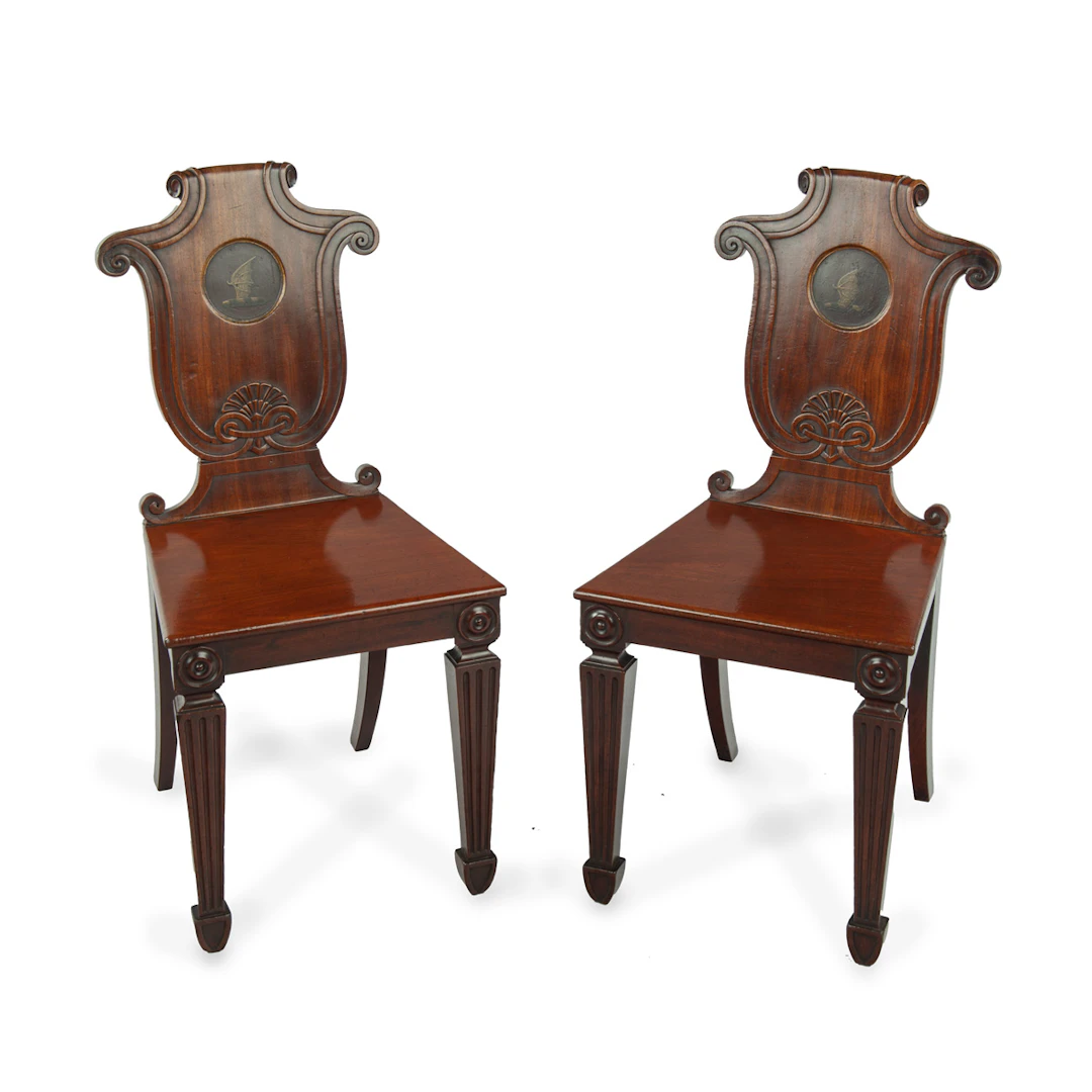 A pair of rare Regency mahogany hall chairs from the Bateson family