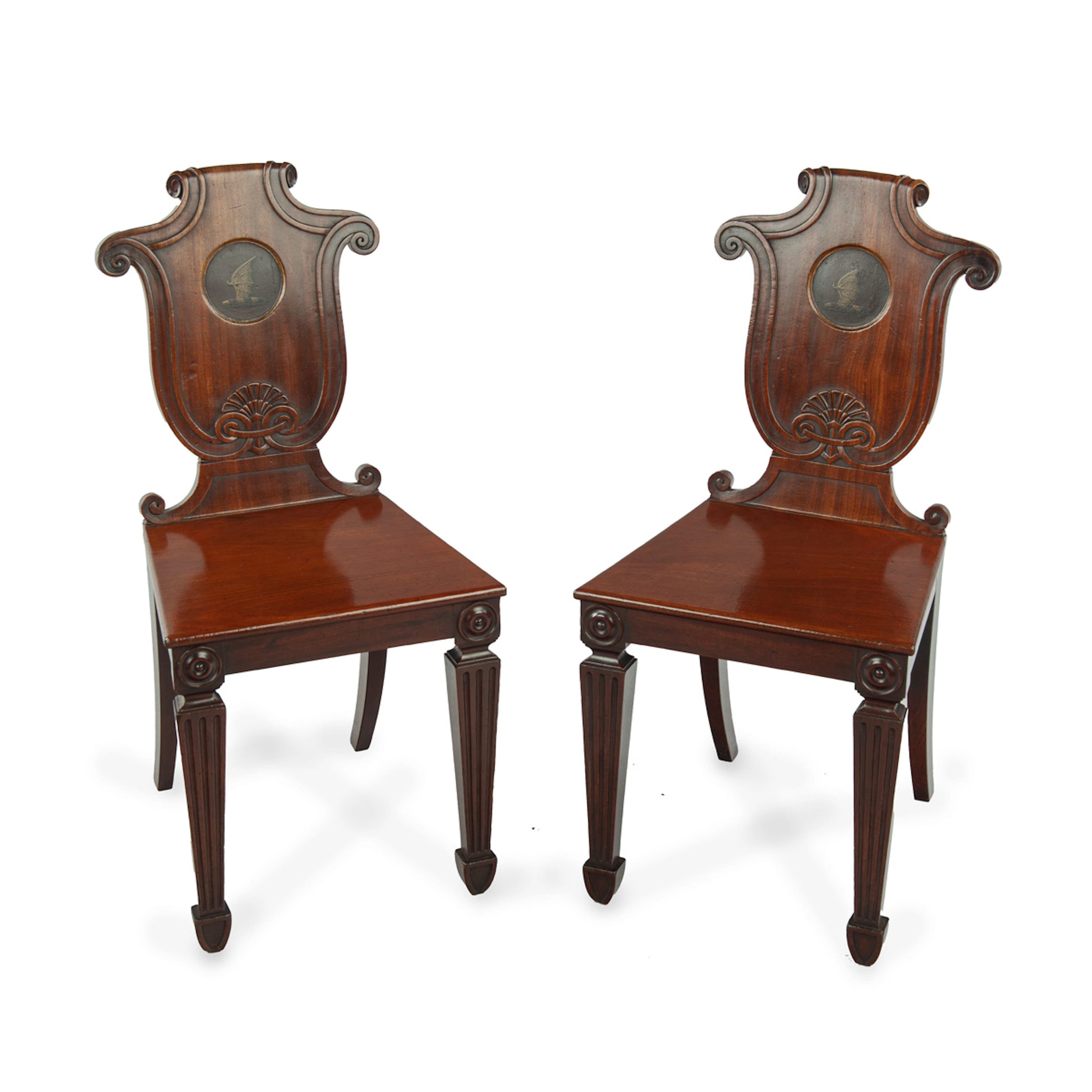 A pair of rare Regency mahogany hall chairs from the Bateson family