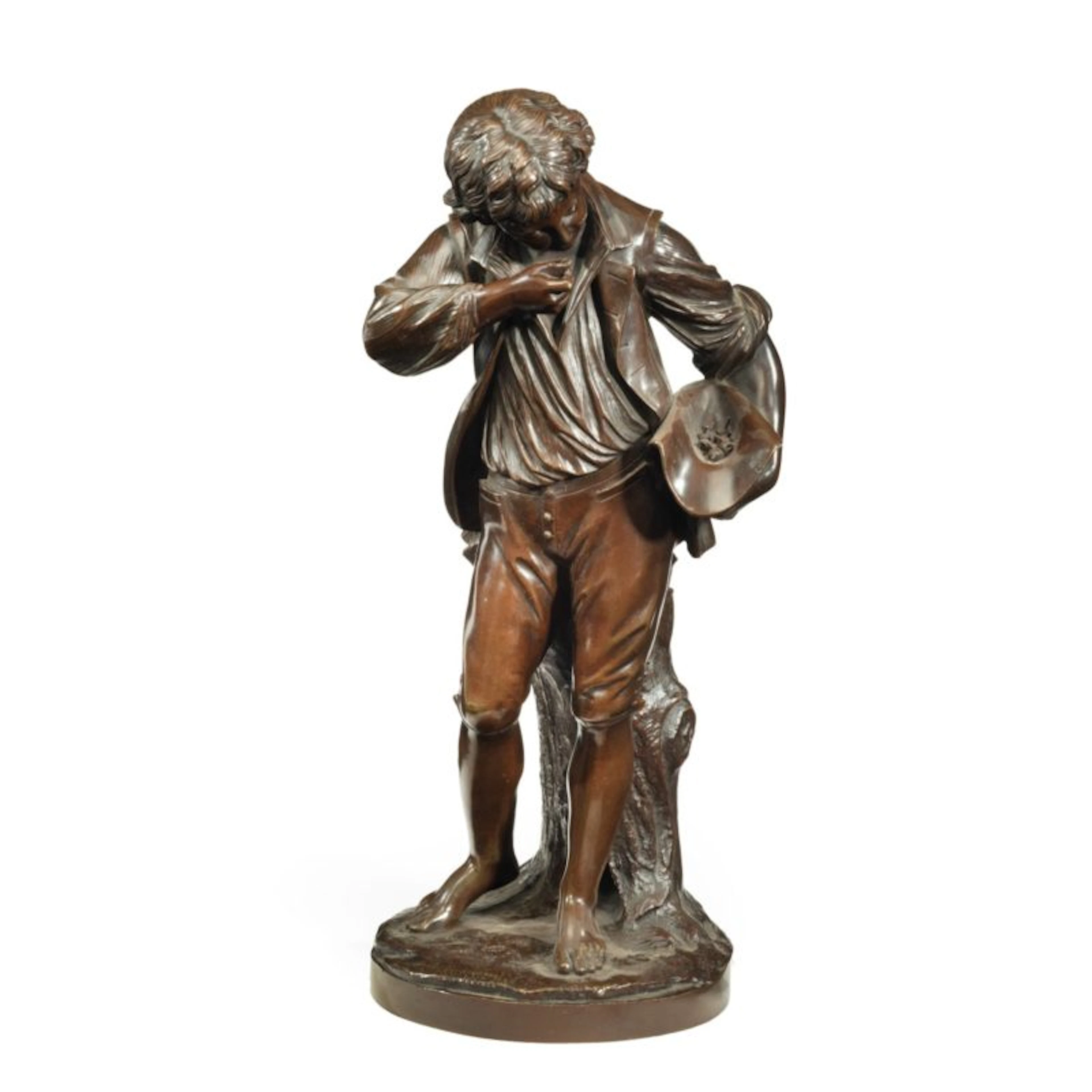 A bronze study of a boy collecting fruit in his wide brimmed hat