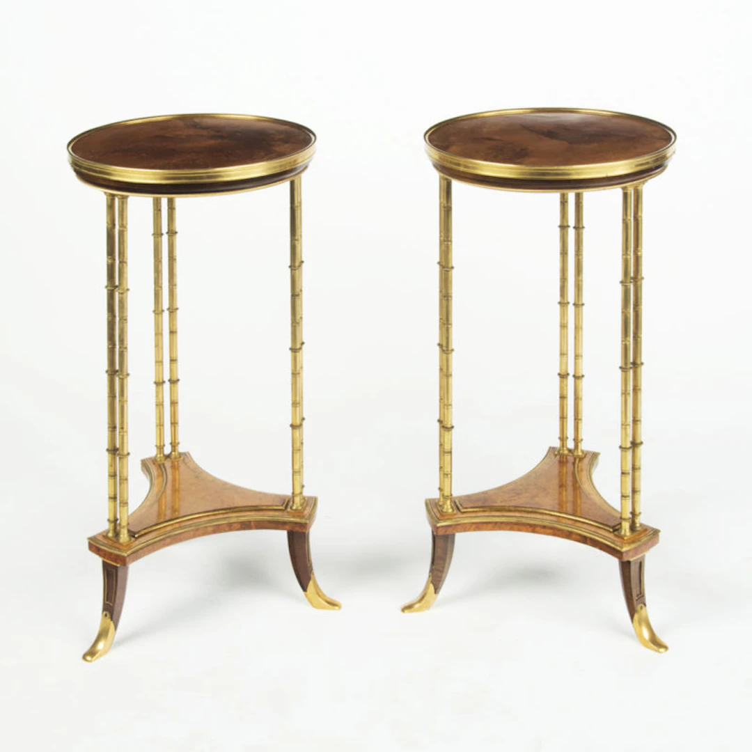 A pair of Louis XVI style mahogany and ormolu gueridons, after Adam Weisweiler