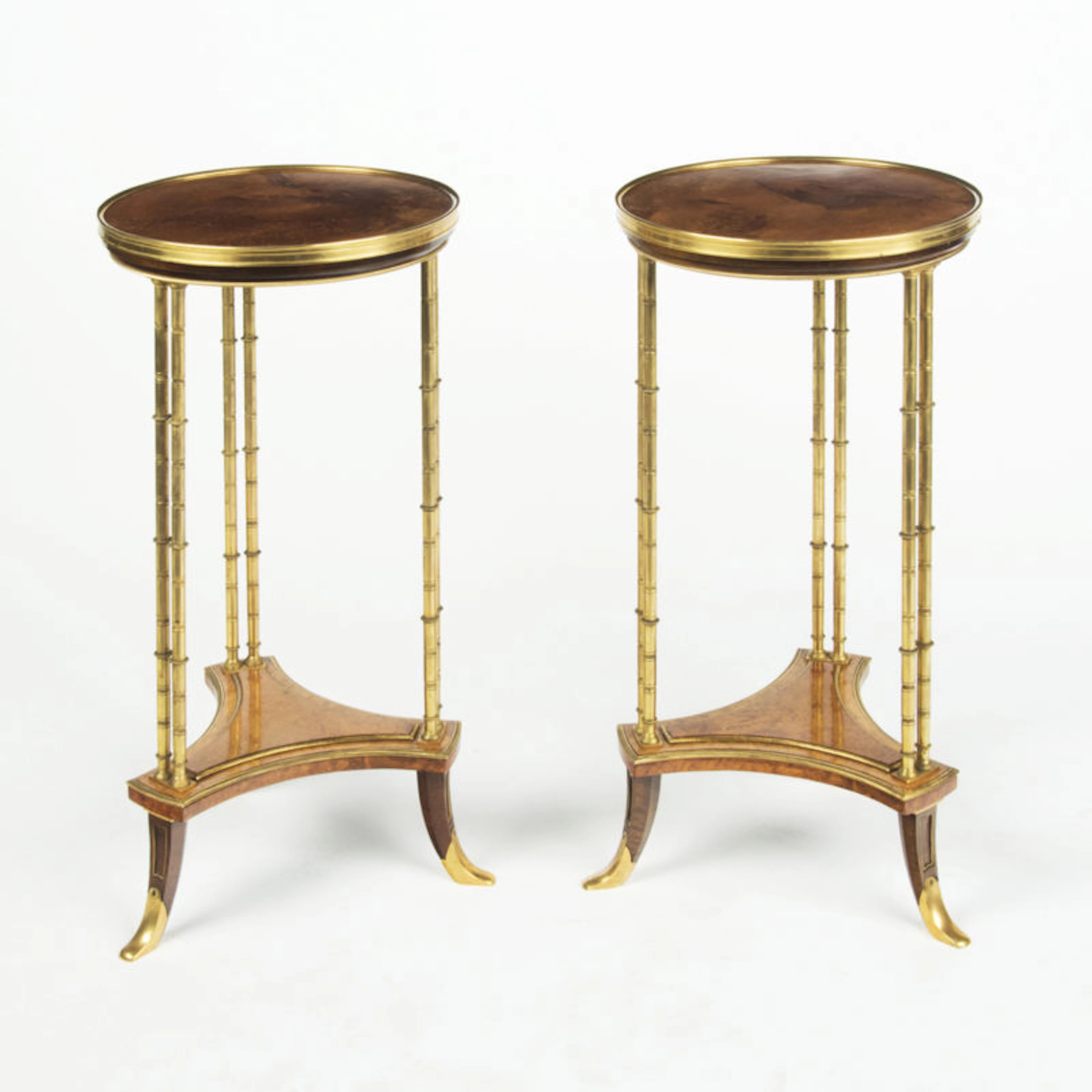 A pair of Louis XVI style mahogany and ormolu gueridons, after Adam Weisweiler