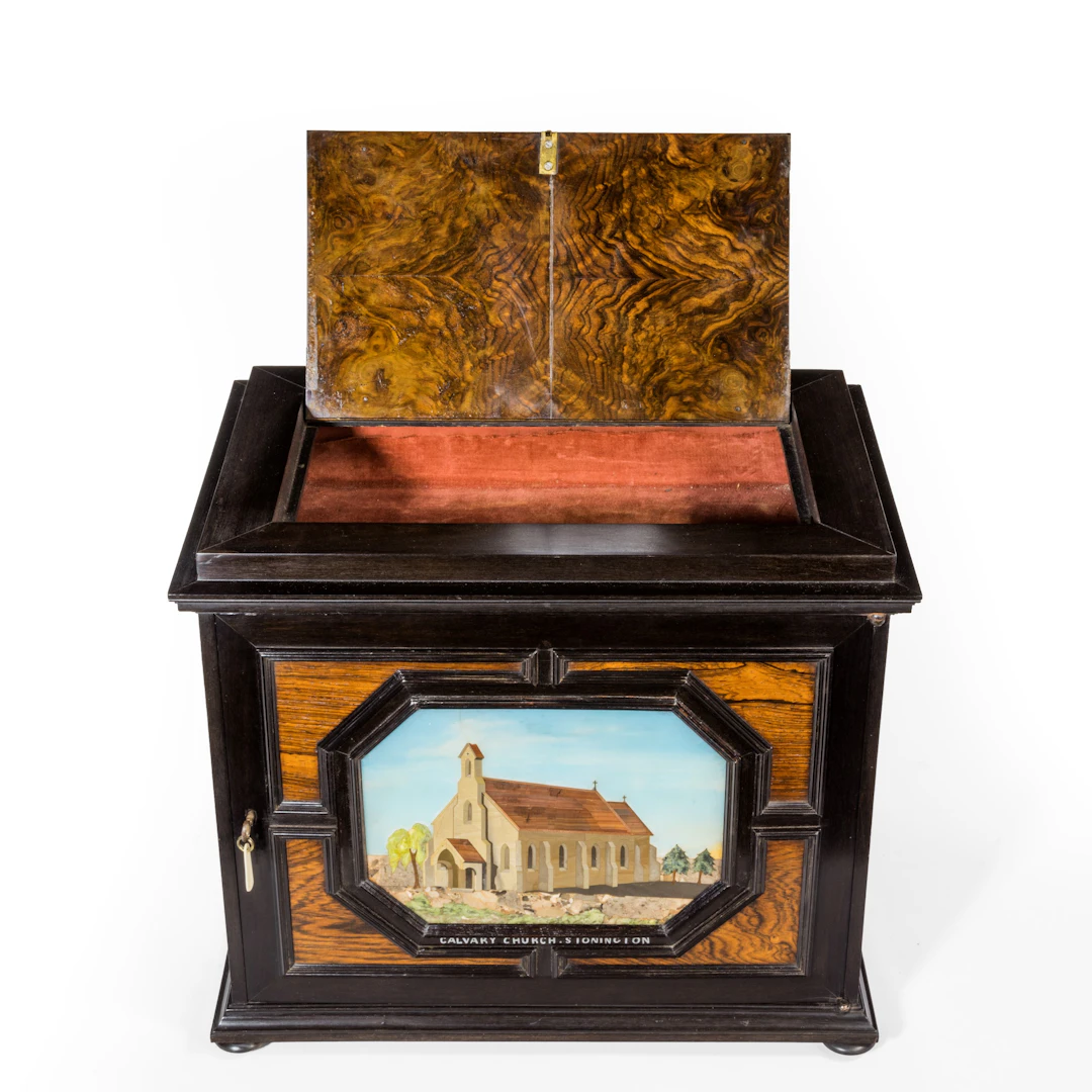 An unusual ebony bijouterie table cabinet showing Calvary Church