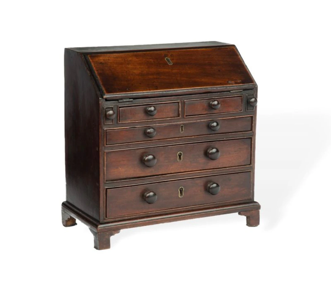A miniature George III mahogany bureau