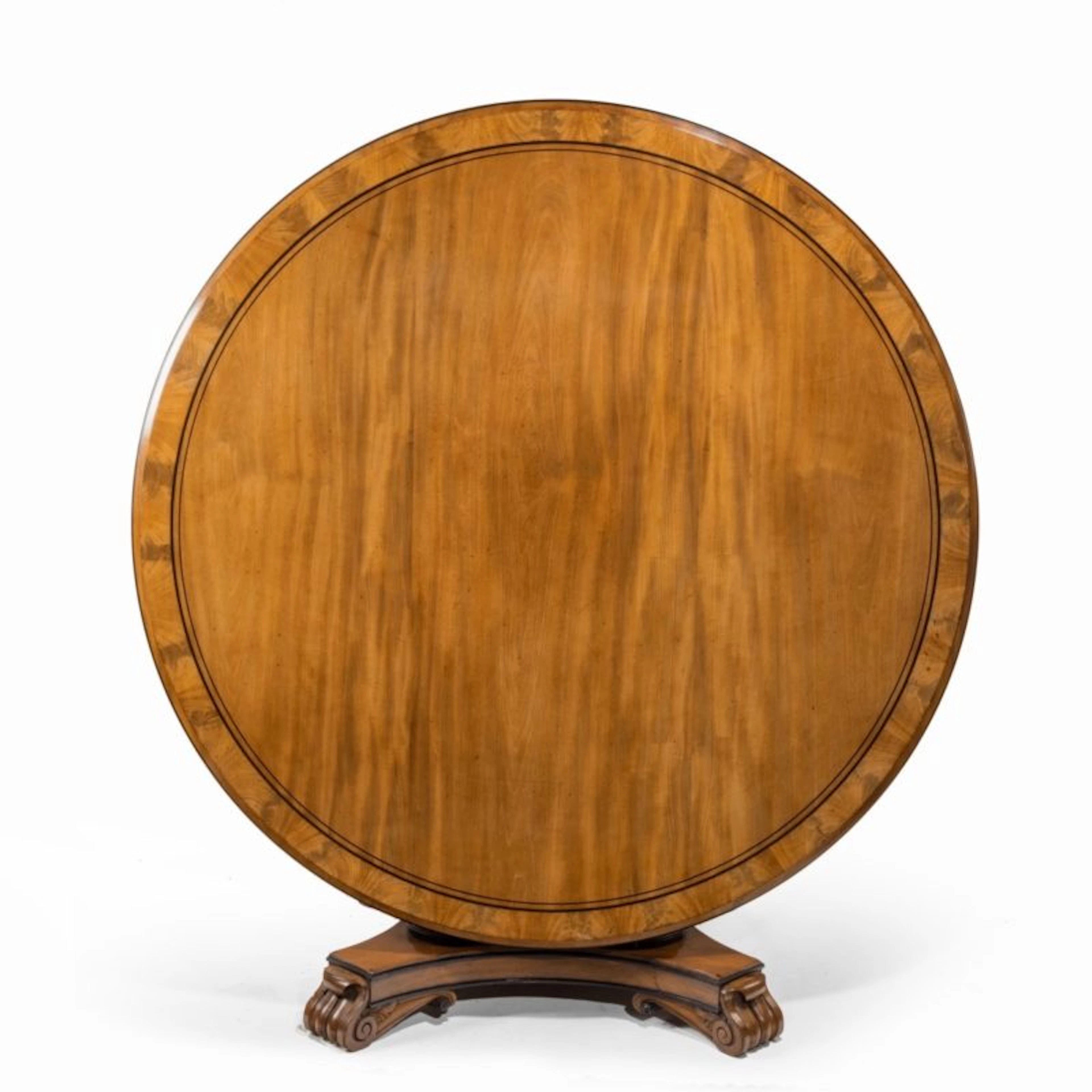 A George IV ebony-inlaid mahogany tilt-top centre table