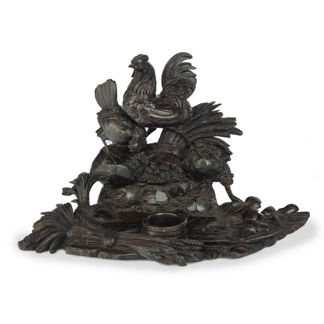 A Black Forest carved wood inkwell with wheat sheafs and poultry