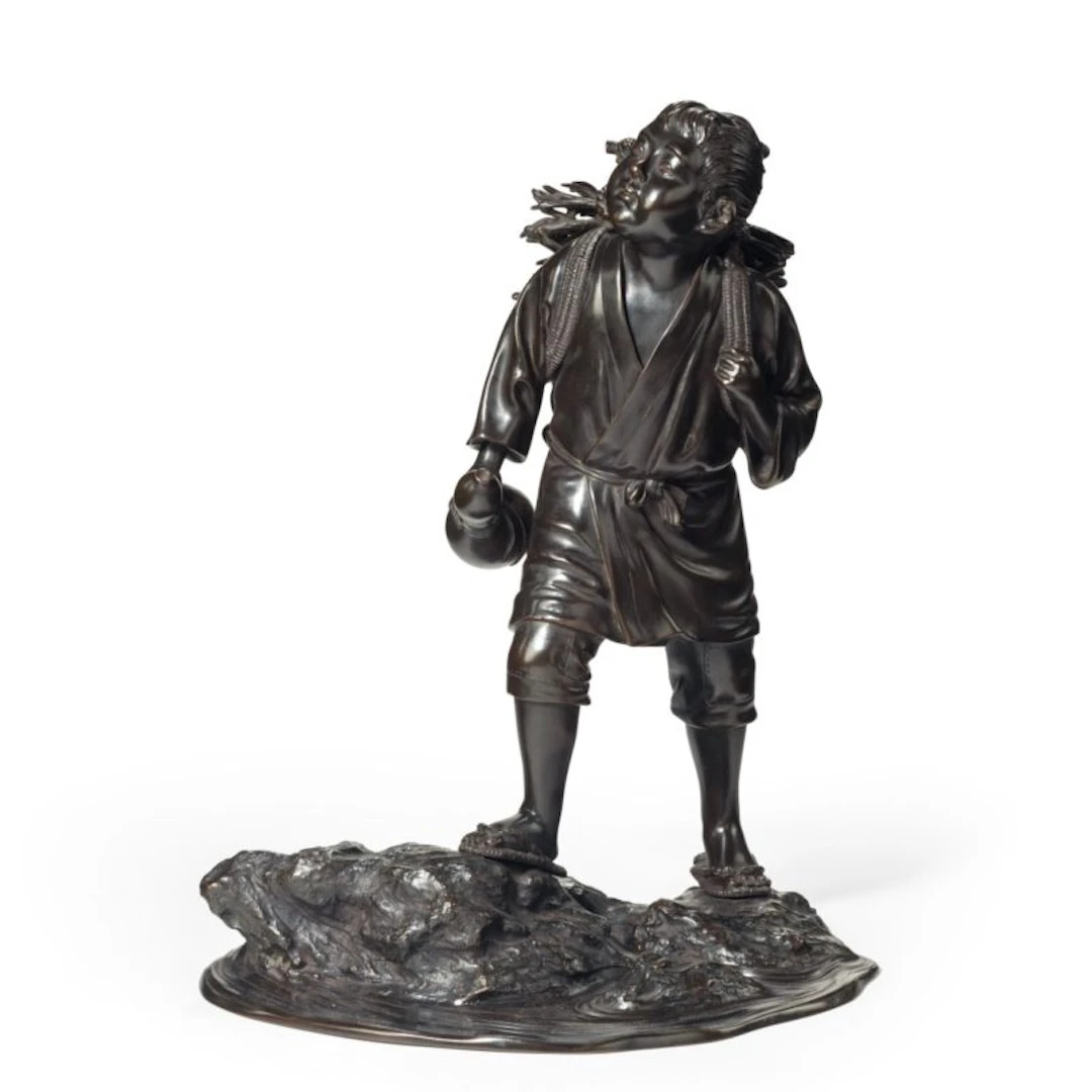 A Meiji period bronze of a boy carrying twigs