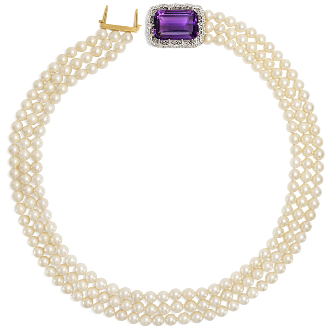 A Fine Cultured Pearl Necklace in Three Strands with an Amethyst Clasp