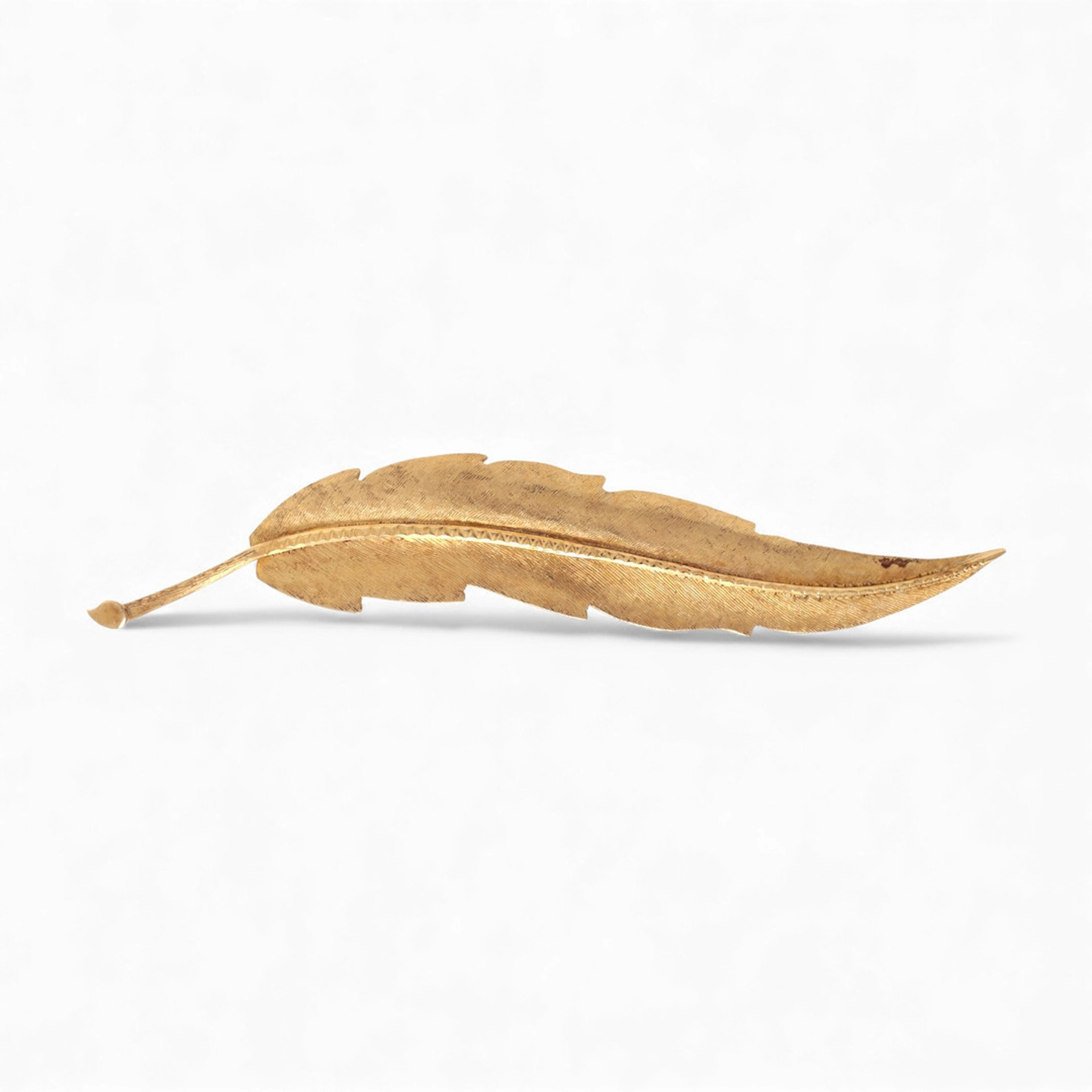 Matte finish leaf-shaped brooch.