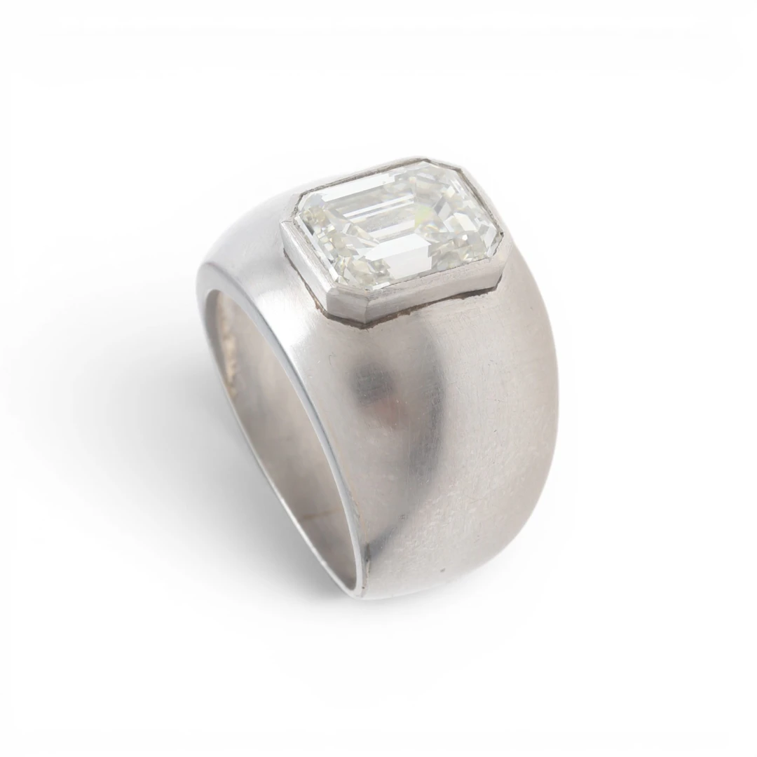 Bombé ring with an emerald cut diamond.