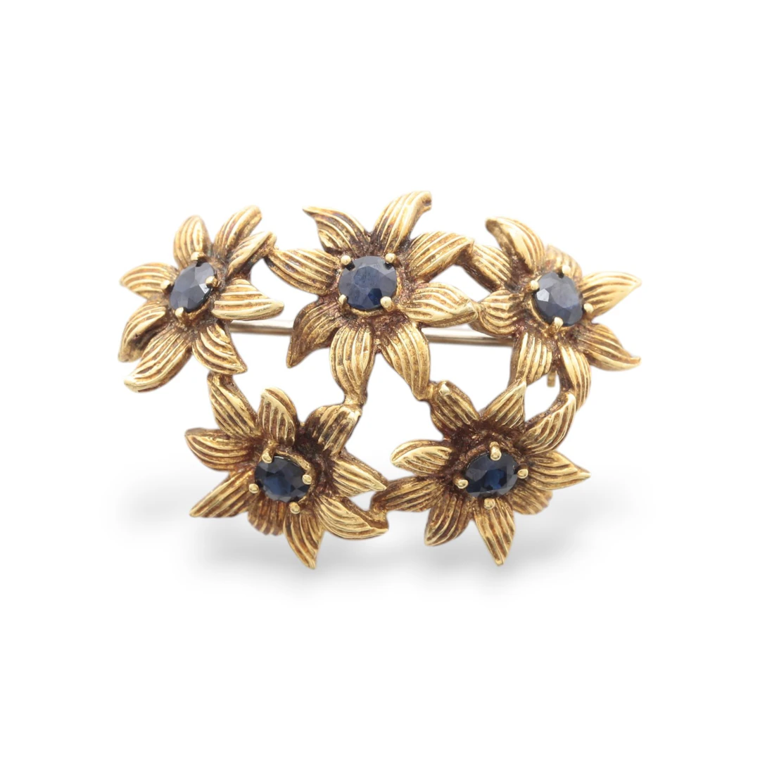 TIFFANY & CO. Gold and sapphires floral brooch, circa 1970.