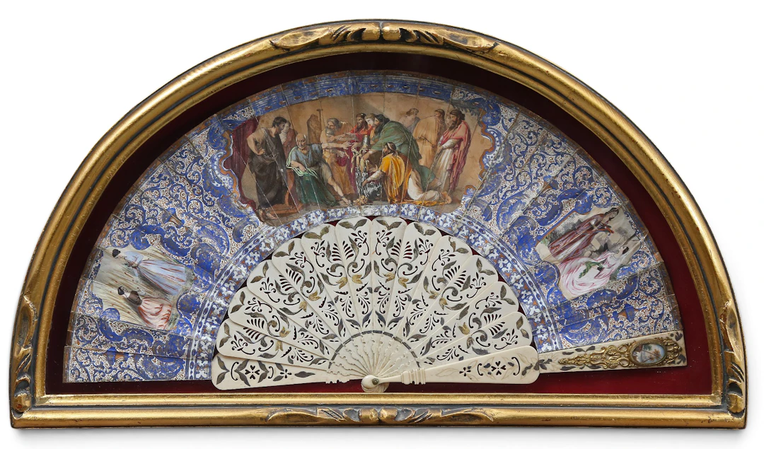 Elizabethan fan with painted and gilt paper leaves and carved and